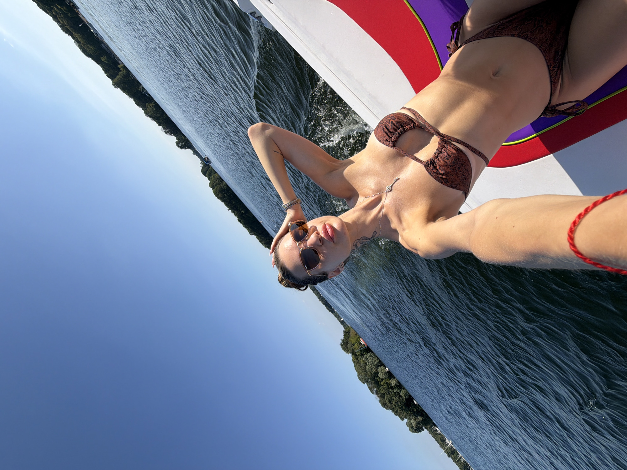 Relaxing on a boat's edge in a brown bikini, summer 2026