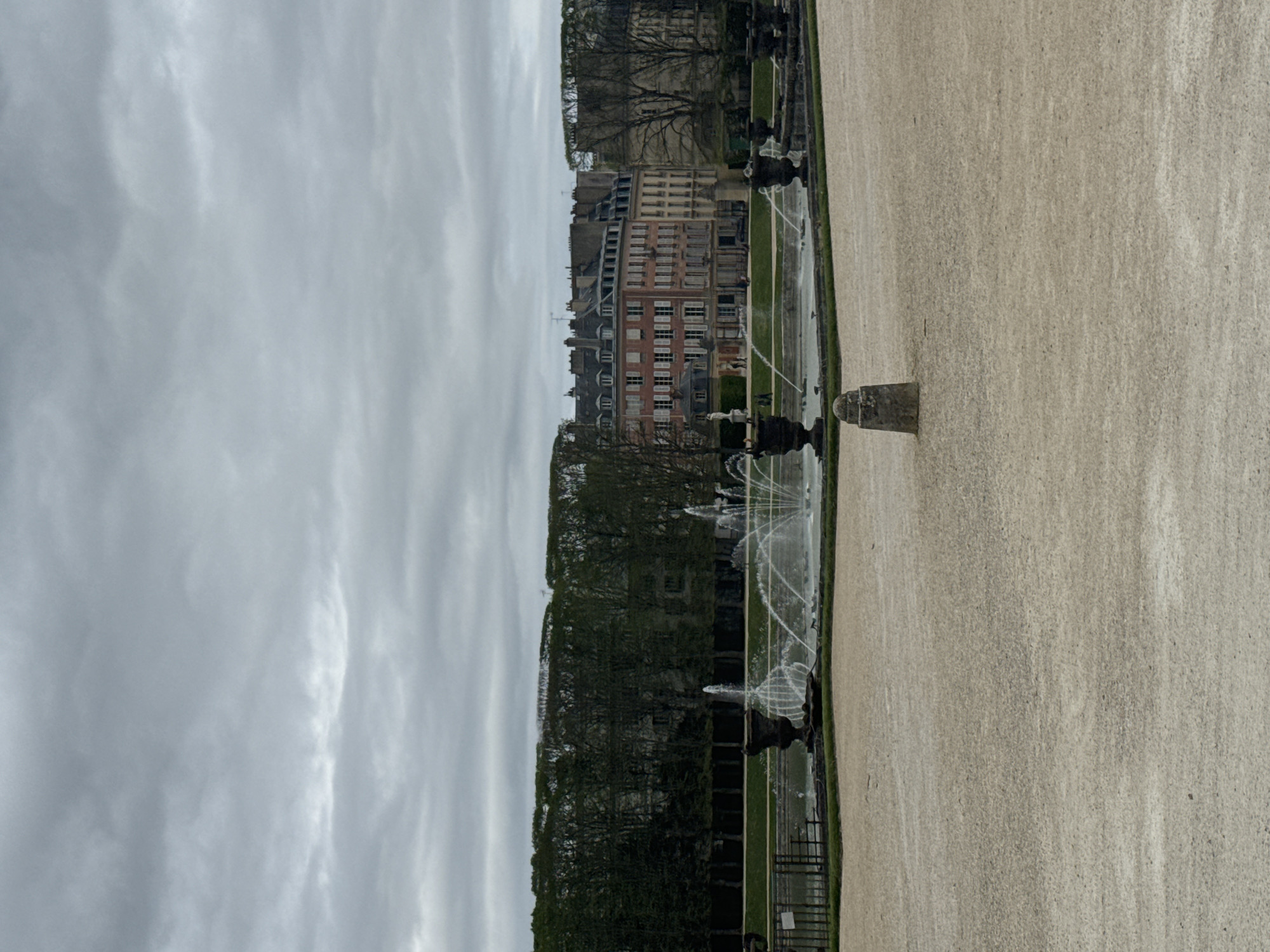 Tourist activity documented at Versailles attractions on overcast afternoon
