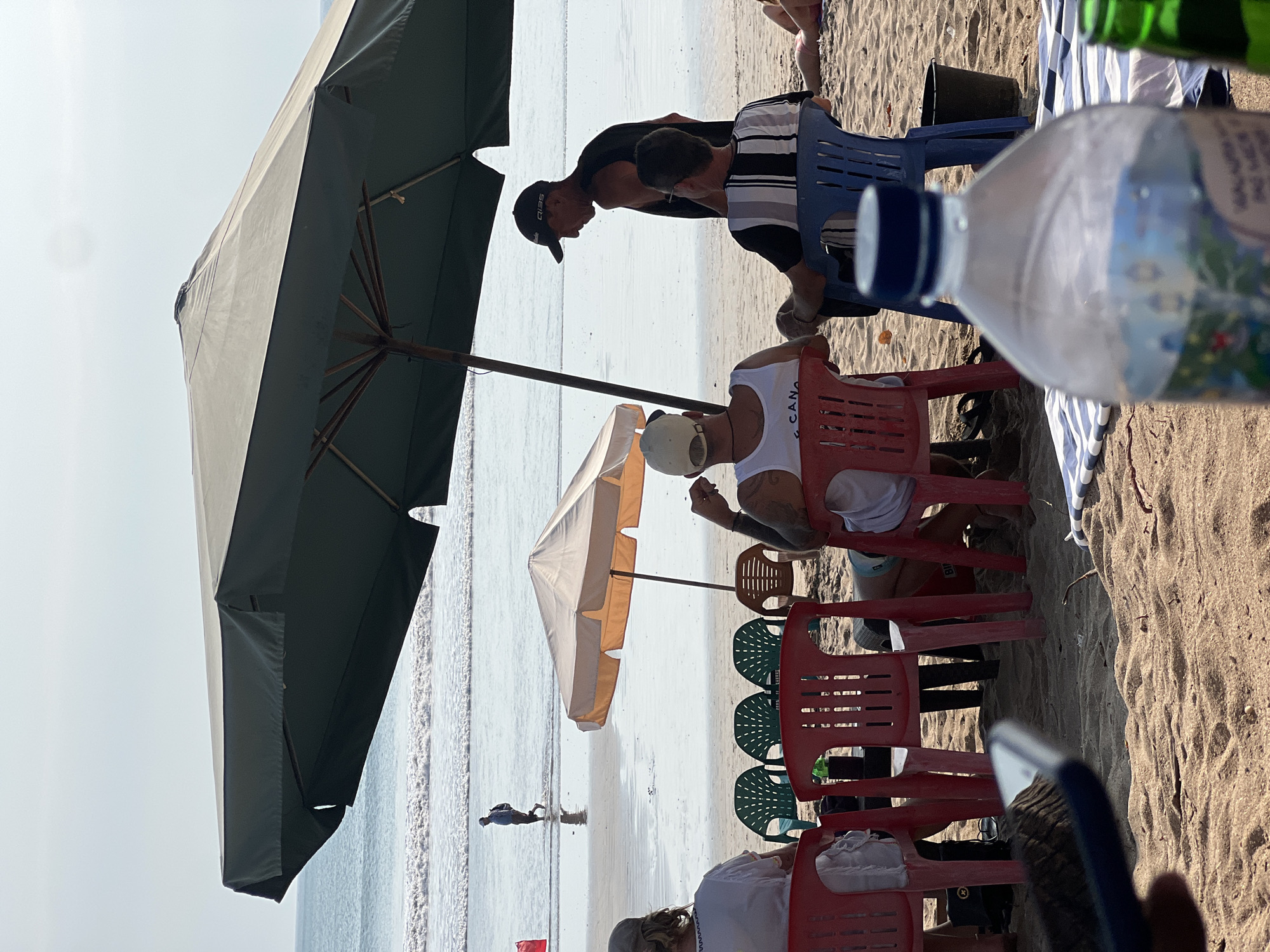 Lazy morning at Kuta Beach, umbrellas, surfboards, and ocean.