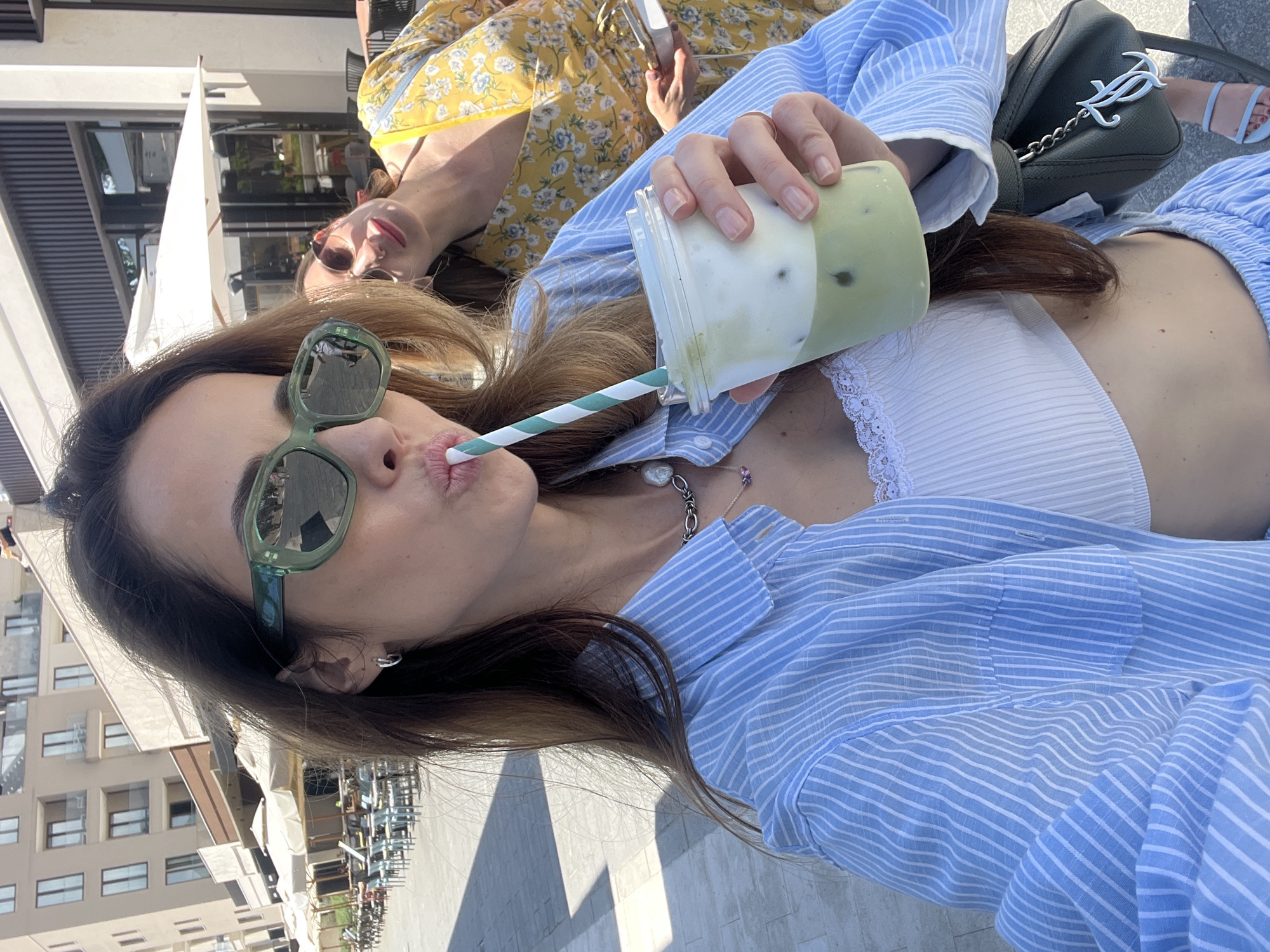 Woman enjoys morning coffee and sightseeing in Tivat, Montenegro