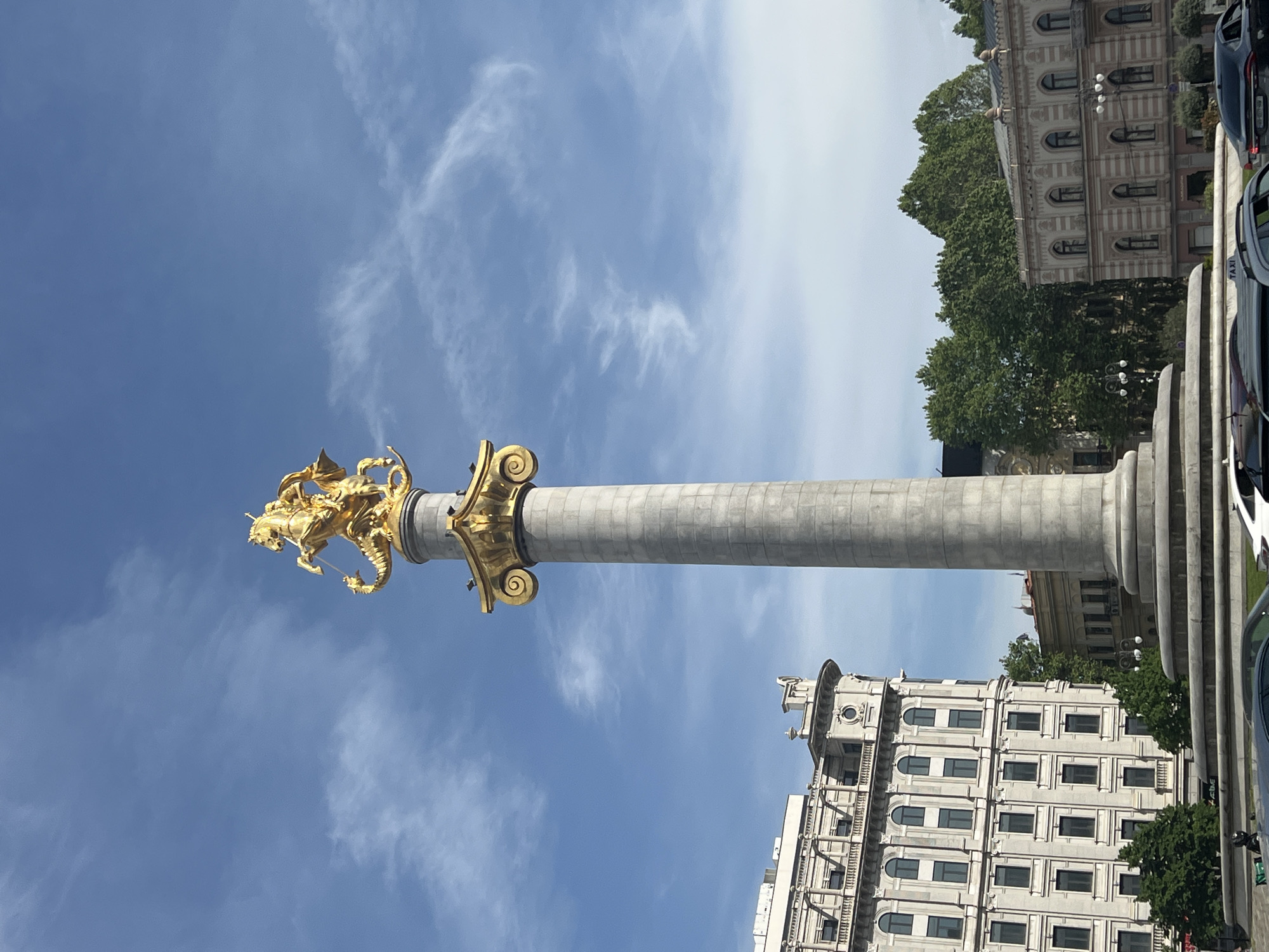 Tourist captures Tbilisi landmarks and Georgian cultural souvenir