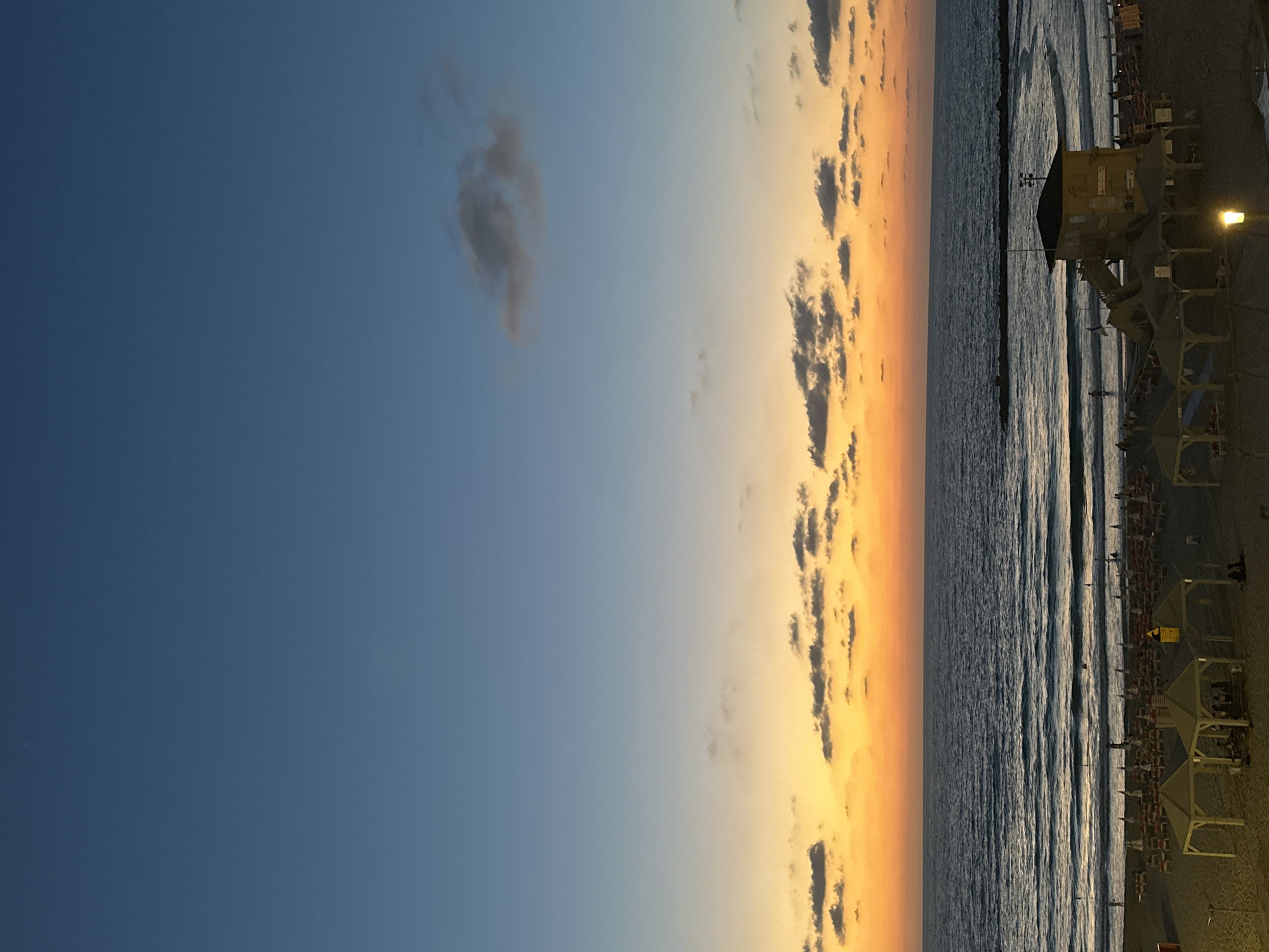 Tel Aviv beach at golden hour, sky ablaze with color