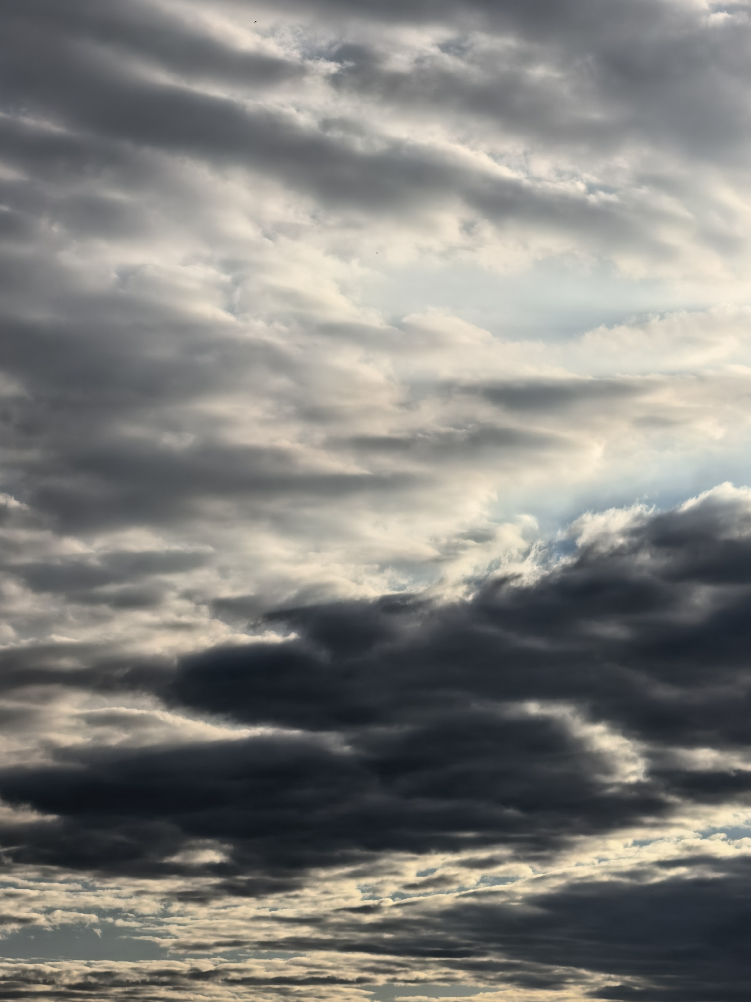 Sun pushing through heavy cloud cover, golden light on the edges