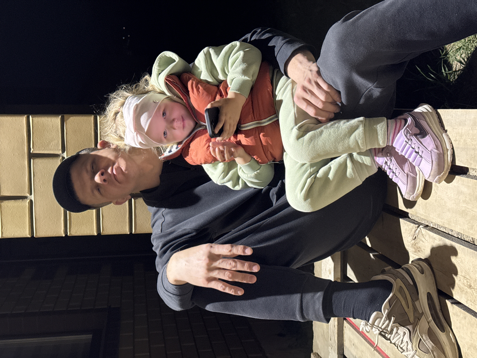 Father and child share quiet moment on wooden structure