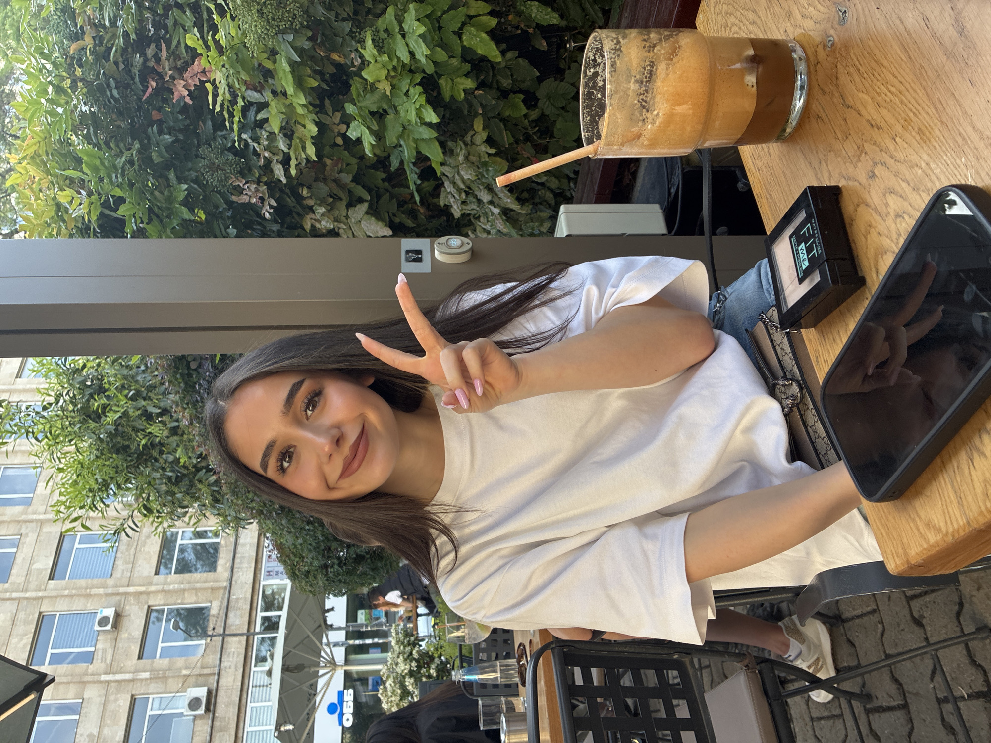Sofia cafe scene: woman poses, guitarist performs outdoors