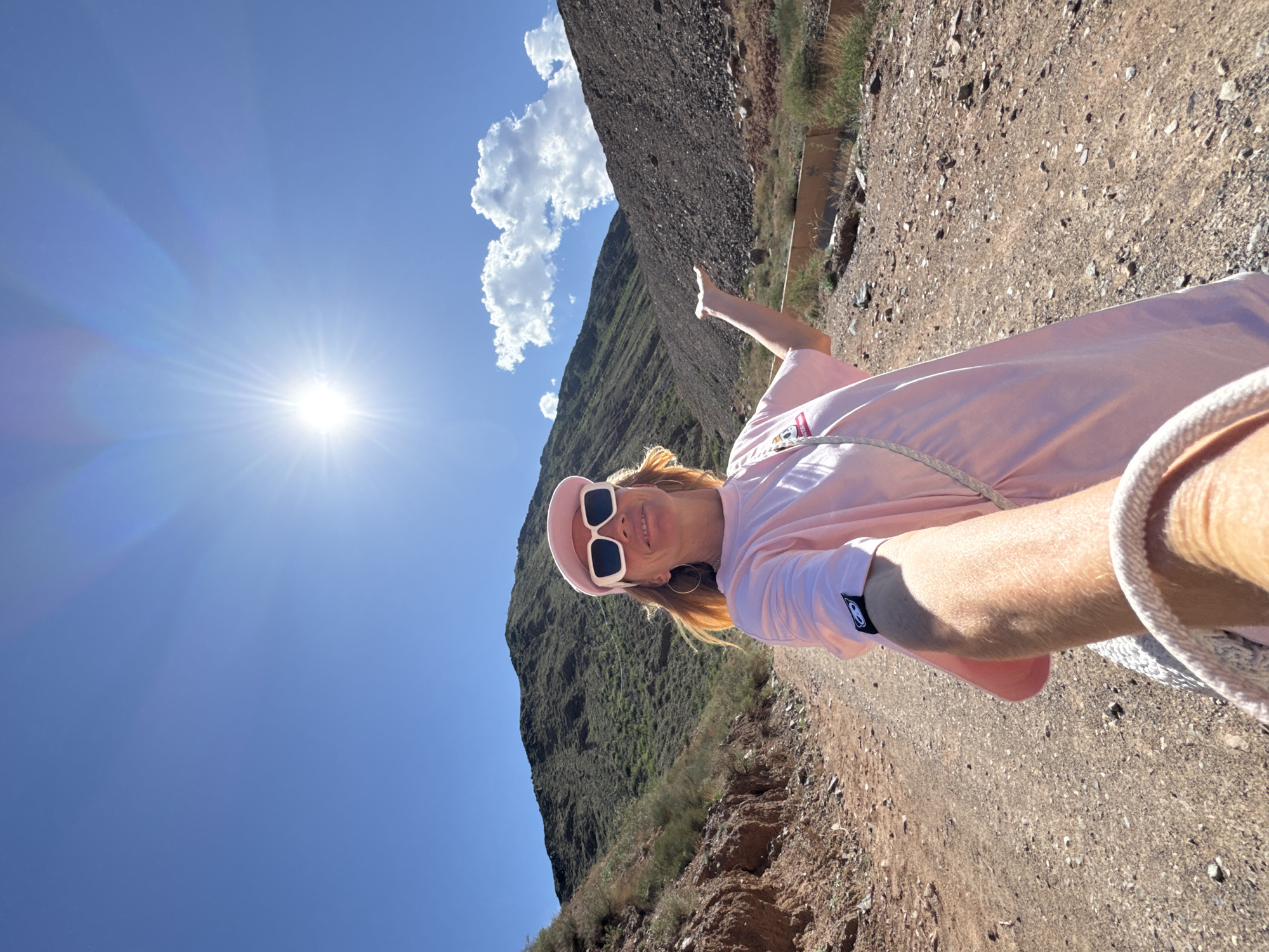 Woman hikes mountain trail near Krasnyy Most, Kyrgyzstan