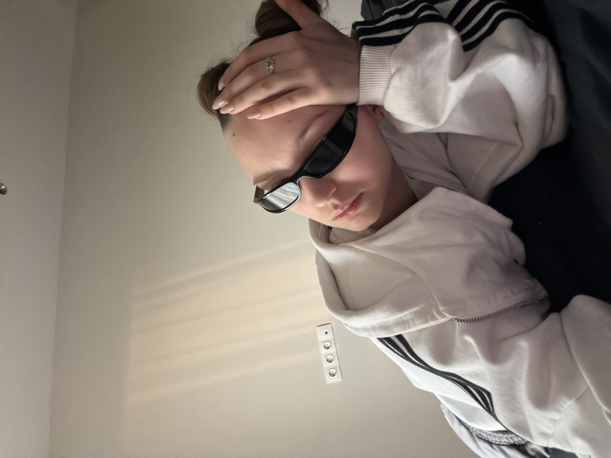 Person in "shadowbanned" shirt rests indoors in Moscow