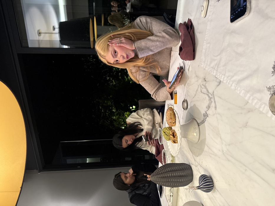 Two women share early morning phone time at Mexico City cafe