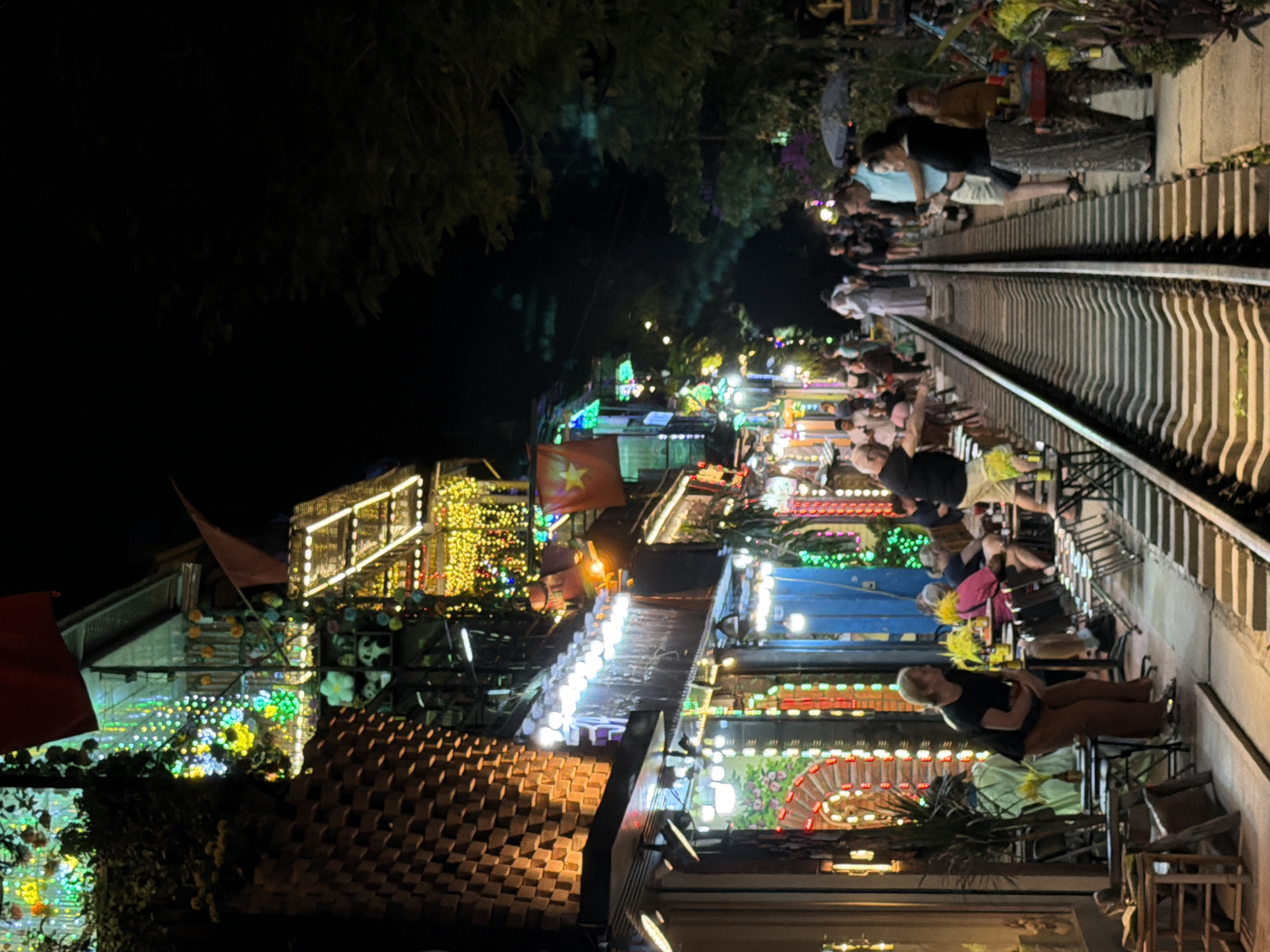 Crowds gather at night on Hanoi's Train Street railway