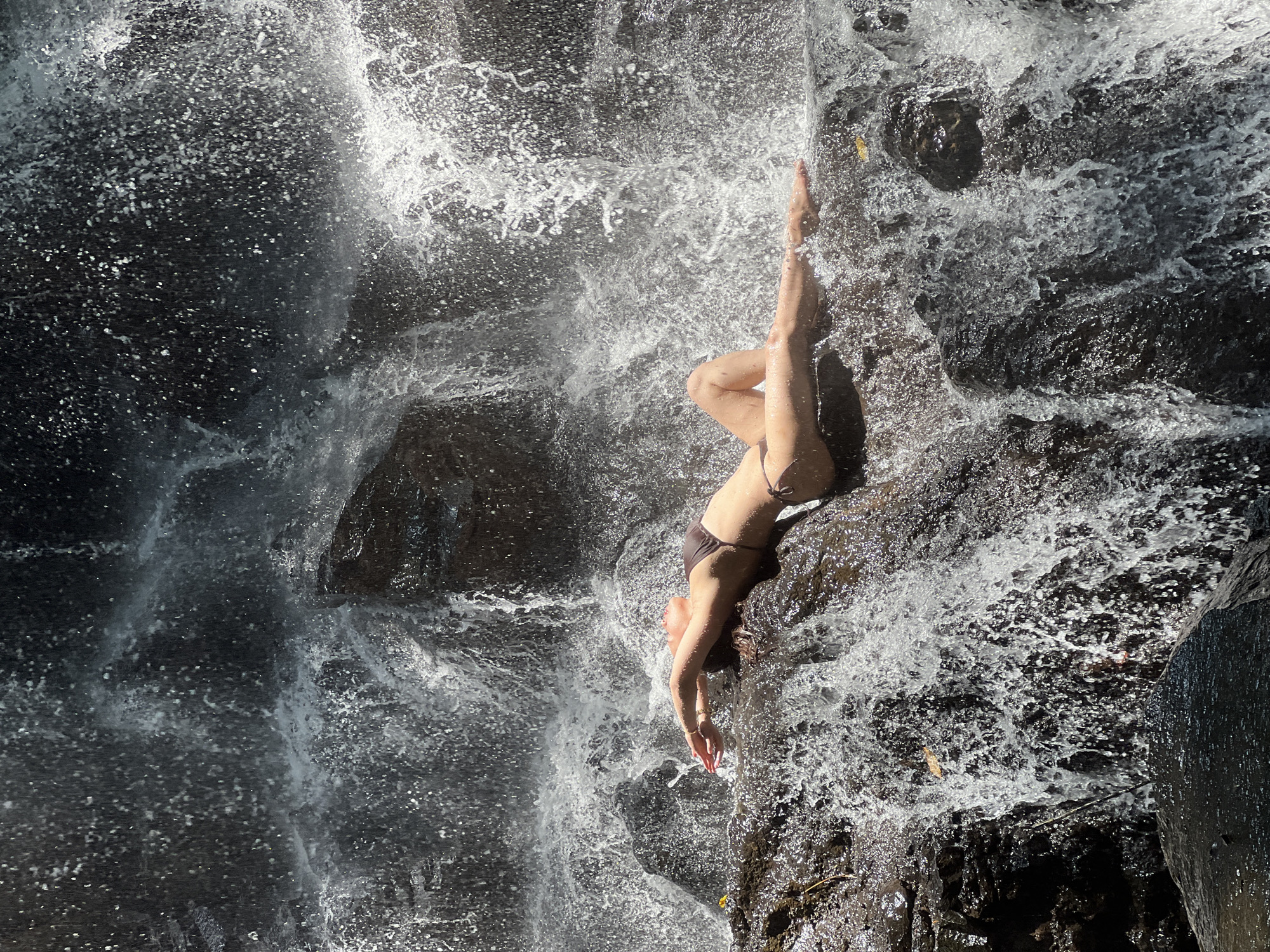 Tourists enjoy waterfall recreation in Gianyar, Indonesia