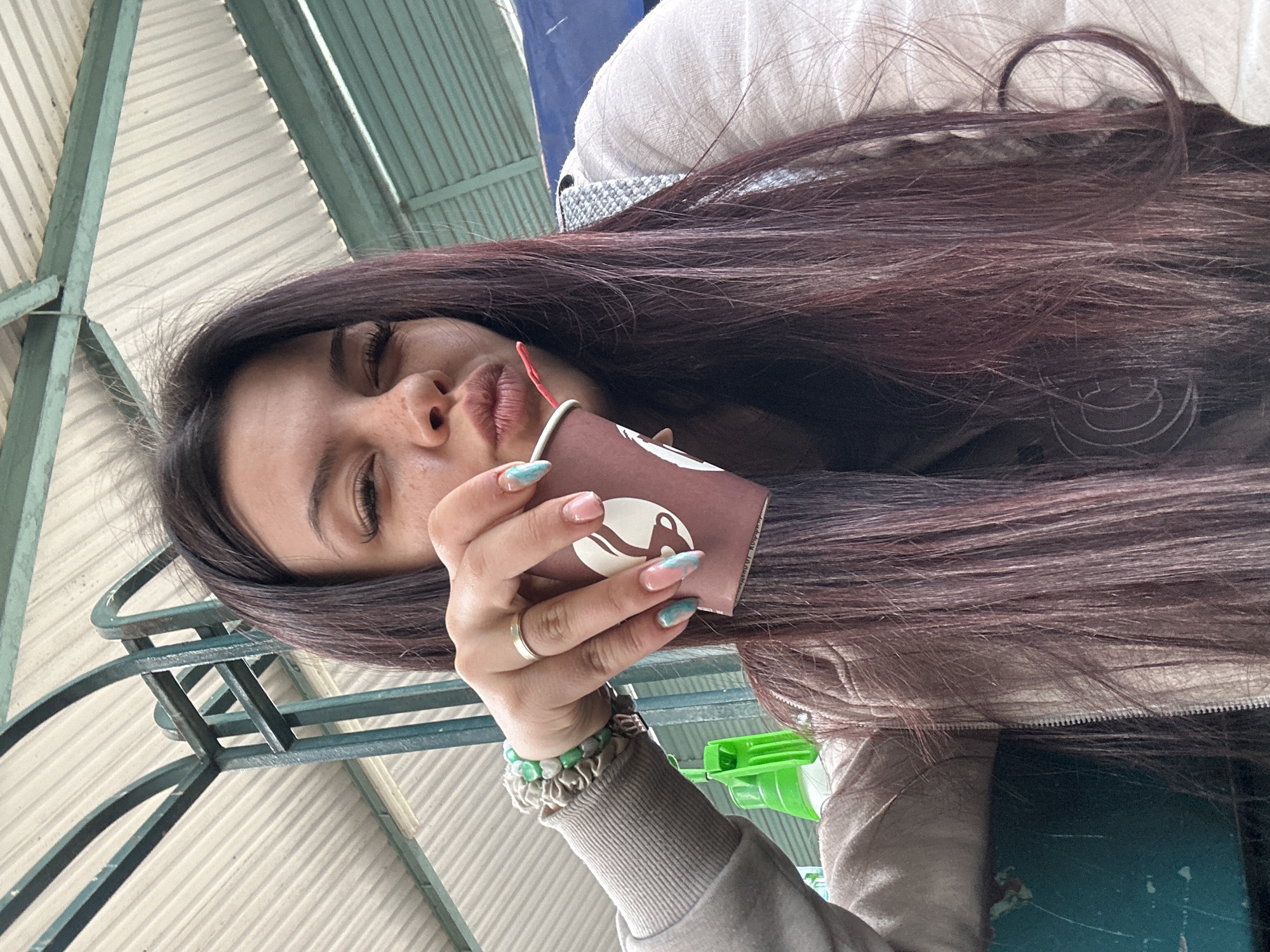 Woman enjoys coffee at Bulgarian produce market in Sliven