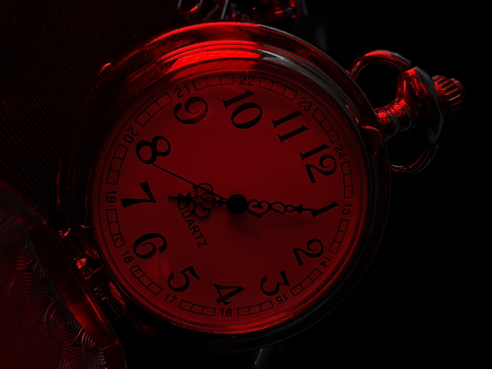 Gothic accessory shoot: pocket watches, spikes, and red lighting