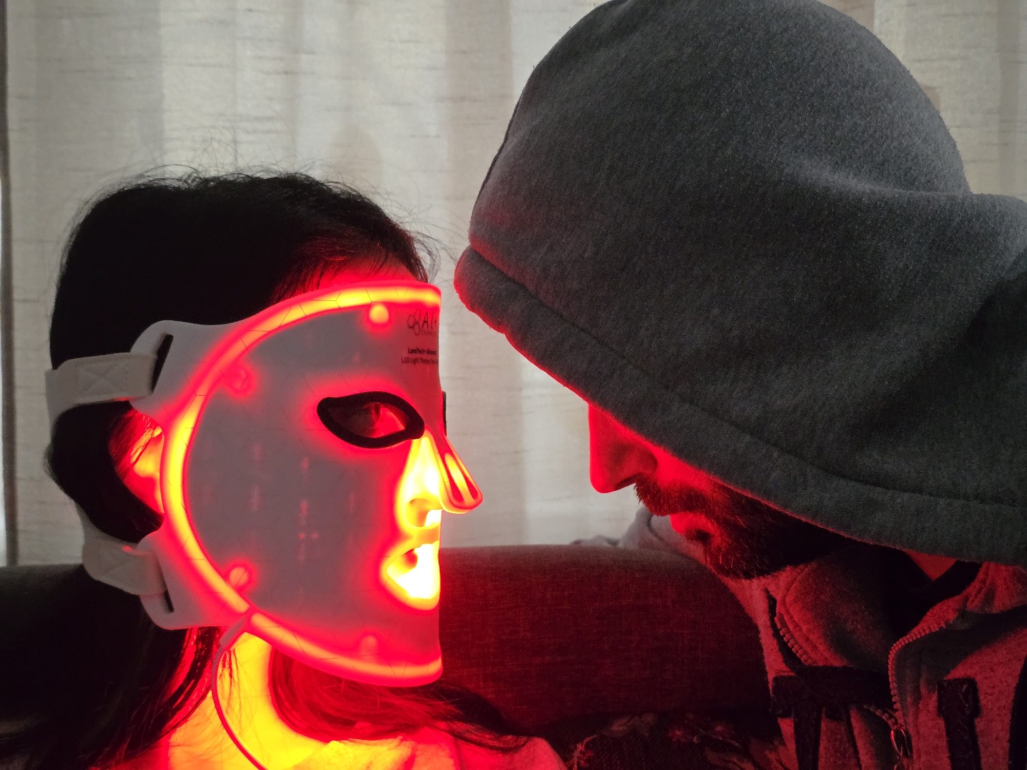 Person spotted wearing glowing red LED facial therapy mask