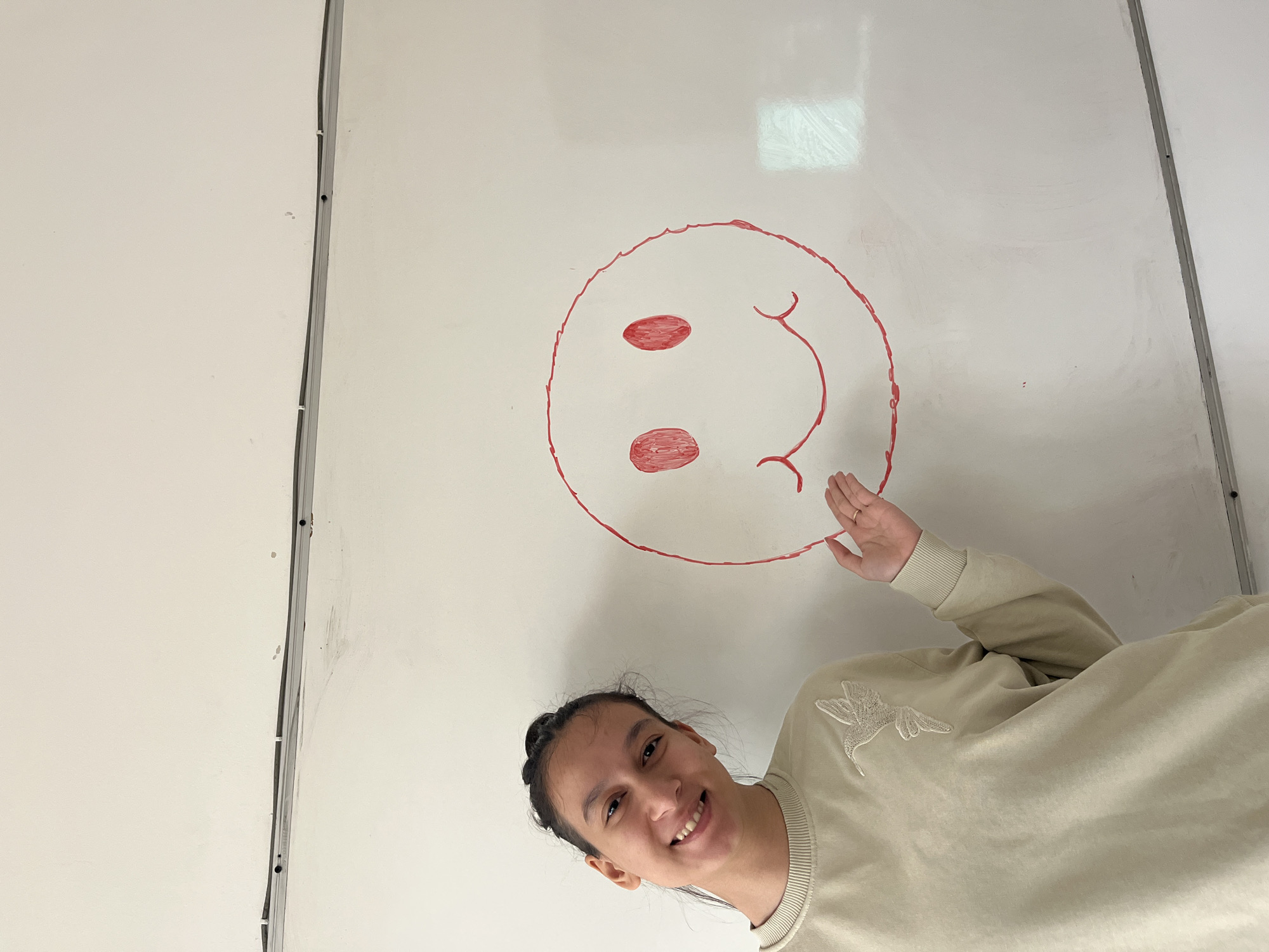 Student poses with artwork in Karnobat classroom setting