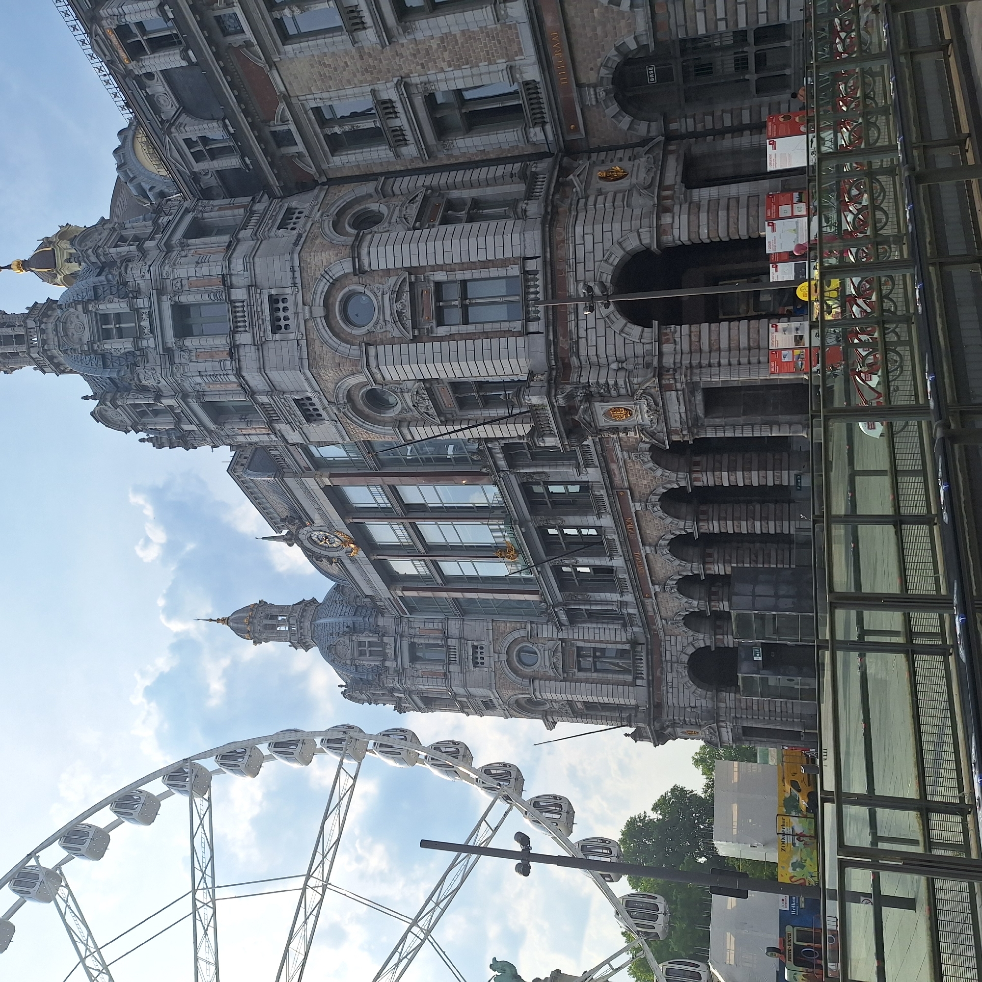 Ferris wheel and grand station define central Antwerp streetscape
