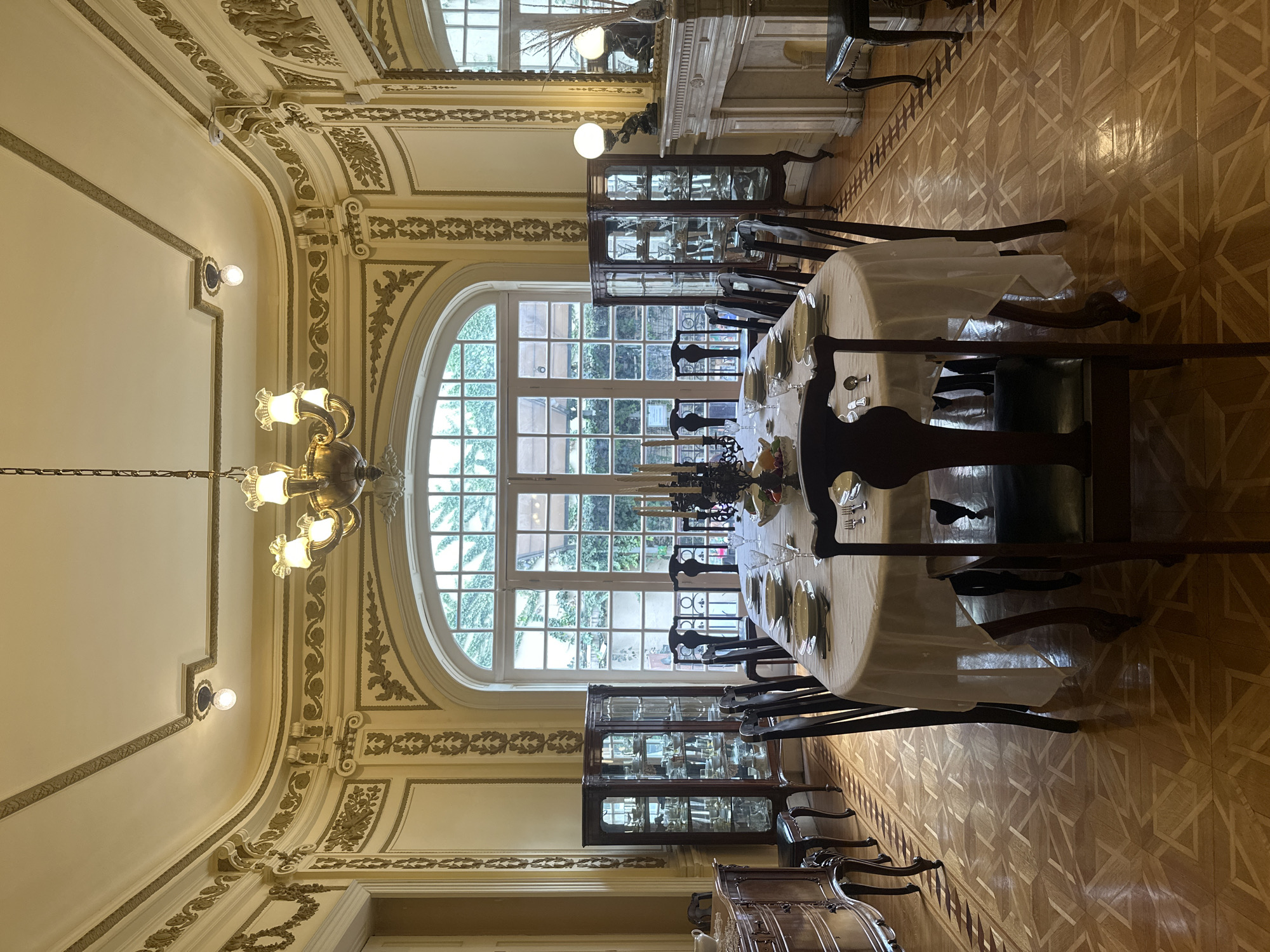 Ornate Mexico City dining room with antique clock and stained glass