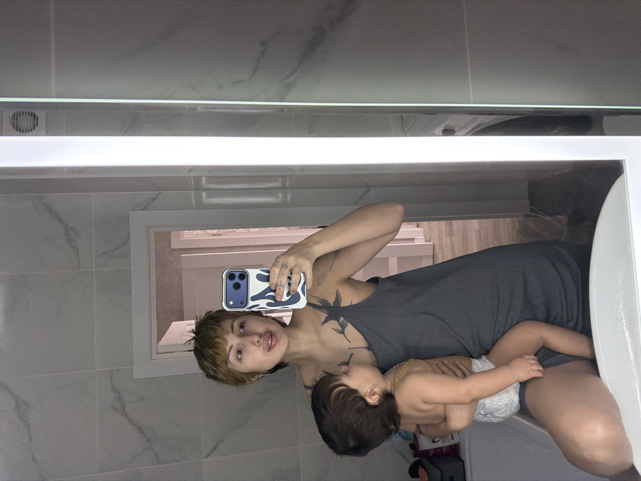 Woman Takes Bathroom Mirror Selfies with Infant in Bataysk