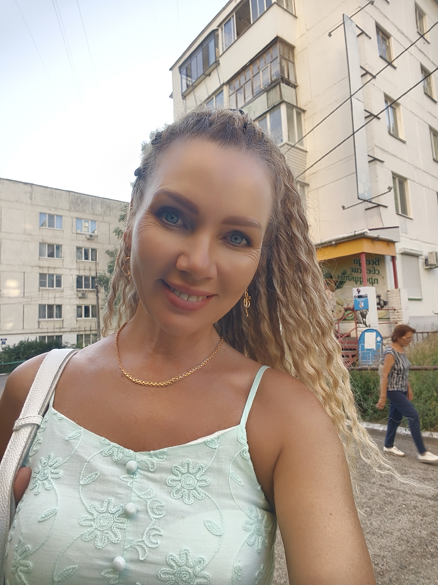 Balcony portrait session in a light blue floral dress