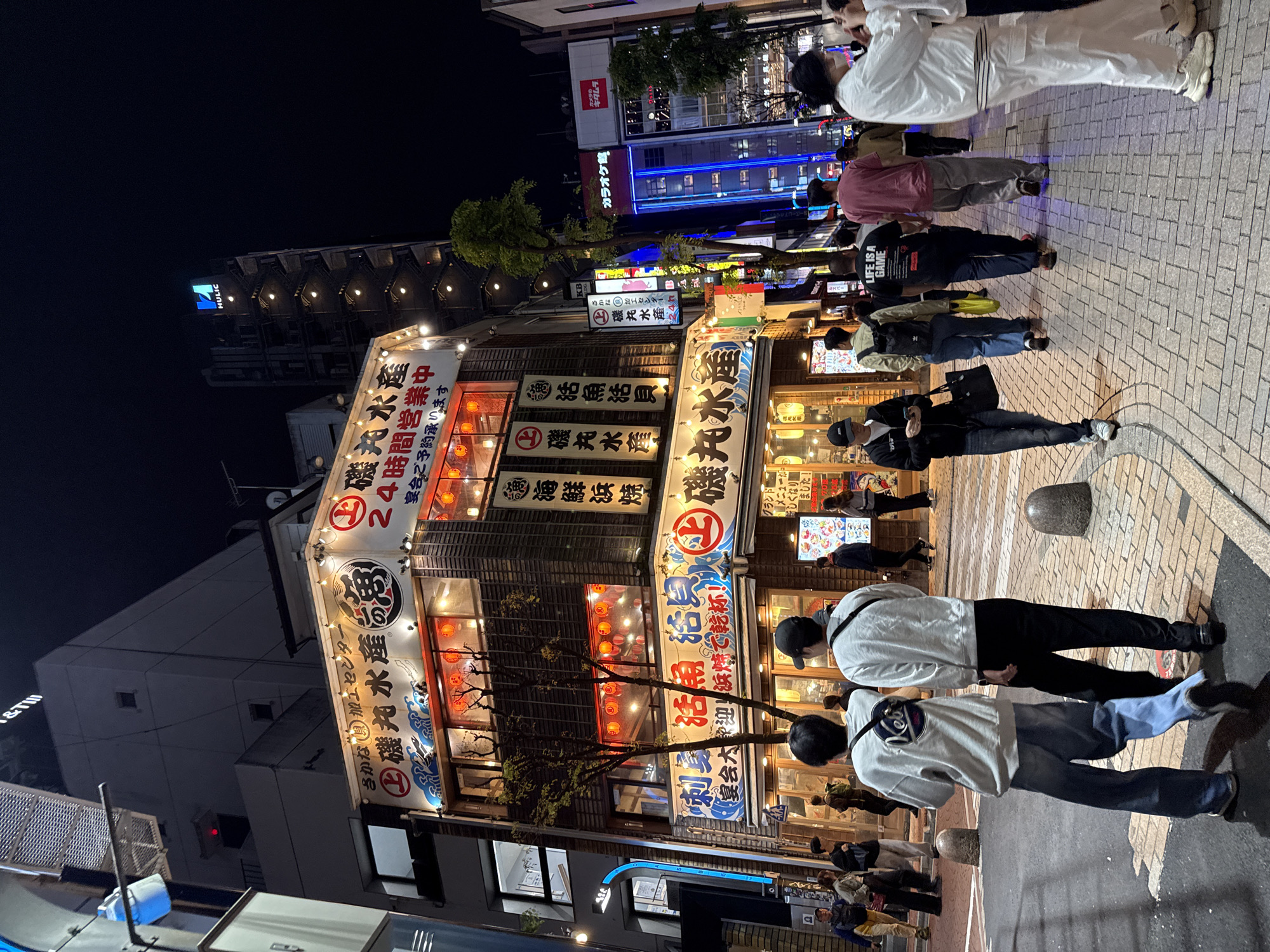 Evening street life documented in Shinjuku commercial district