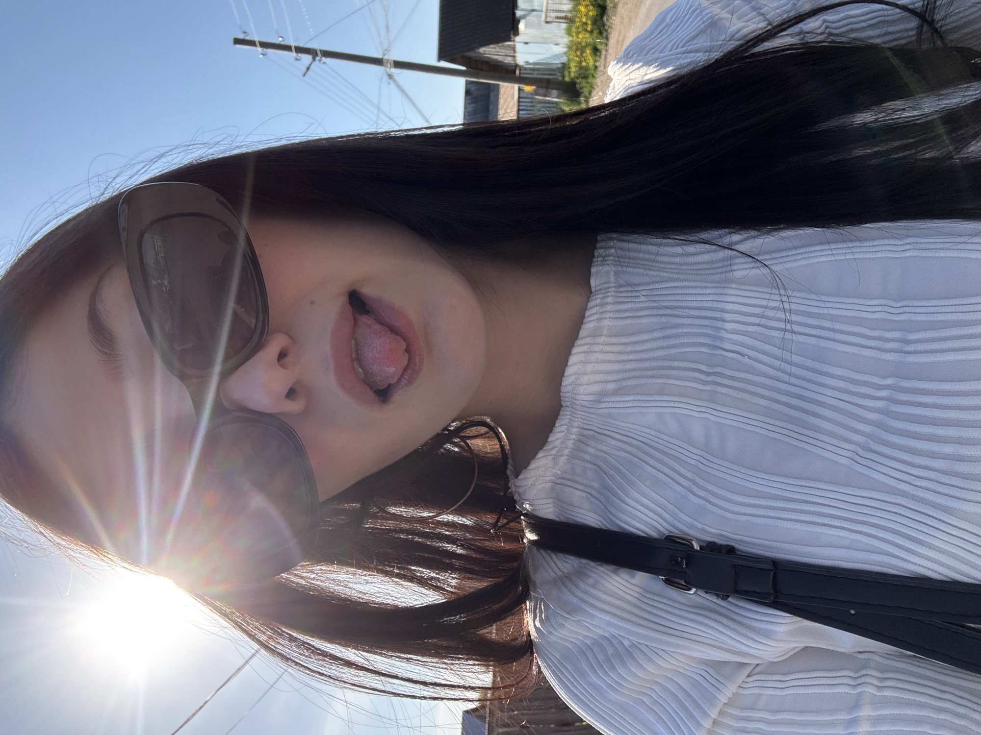 Woman poses playfully in striped shirt in Foki, Russia