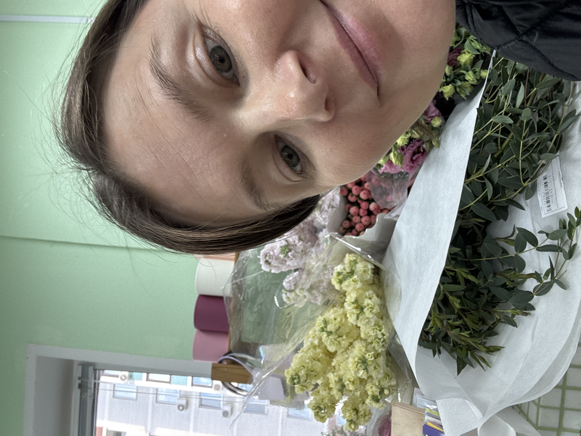 Florist documents flower arranging session in Izhevsk shop