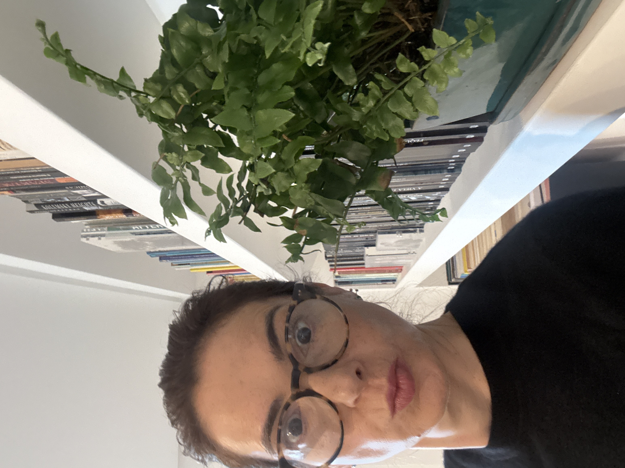 Woman photographed near bookshelf in Vila Nova de Gaia
