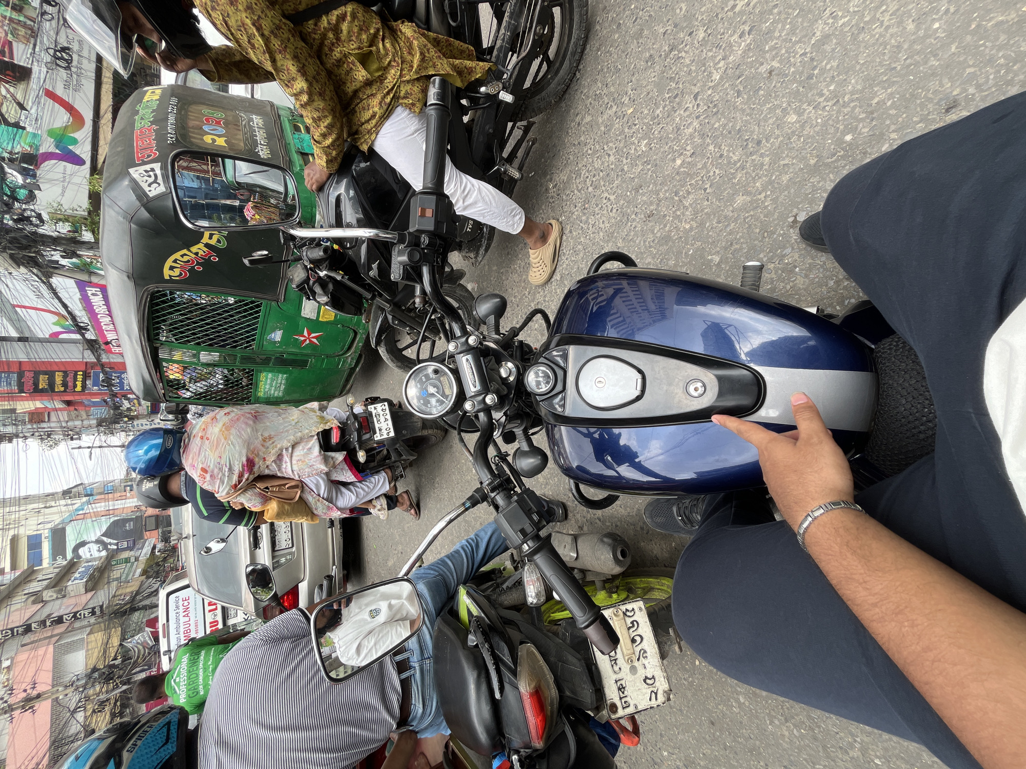 Motorcycle rider caught in morning traffic jam in Dhaka