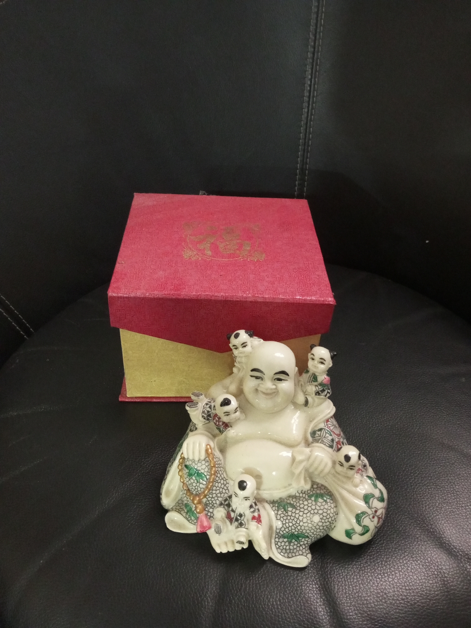 Indoor meal scene with Buddha statue and soup bowl