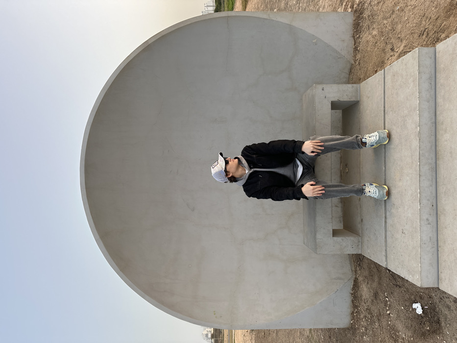 Person sits on steps inside dome structure in Tel Aviv