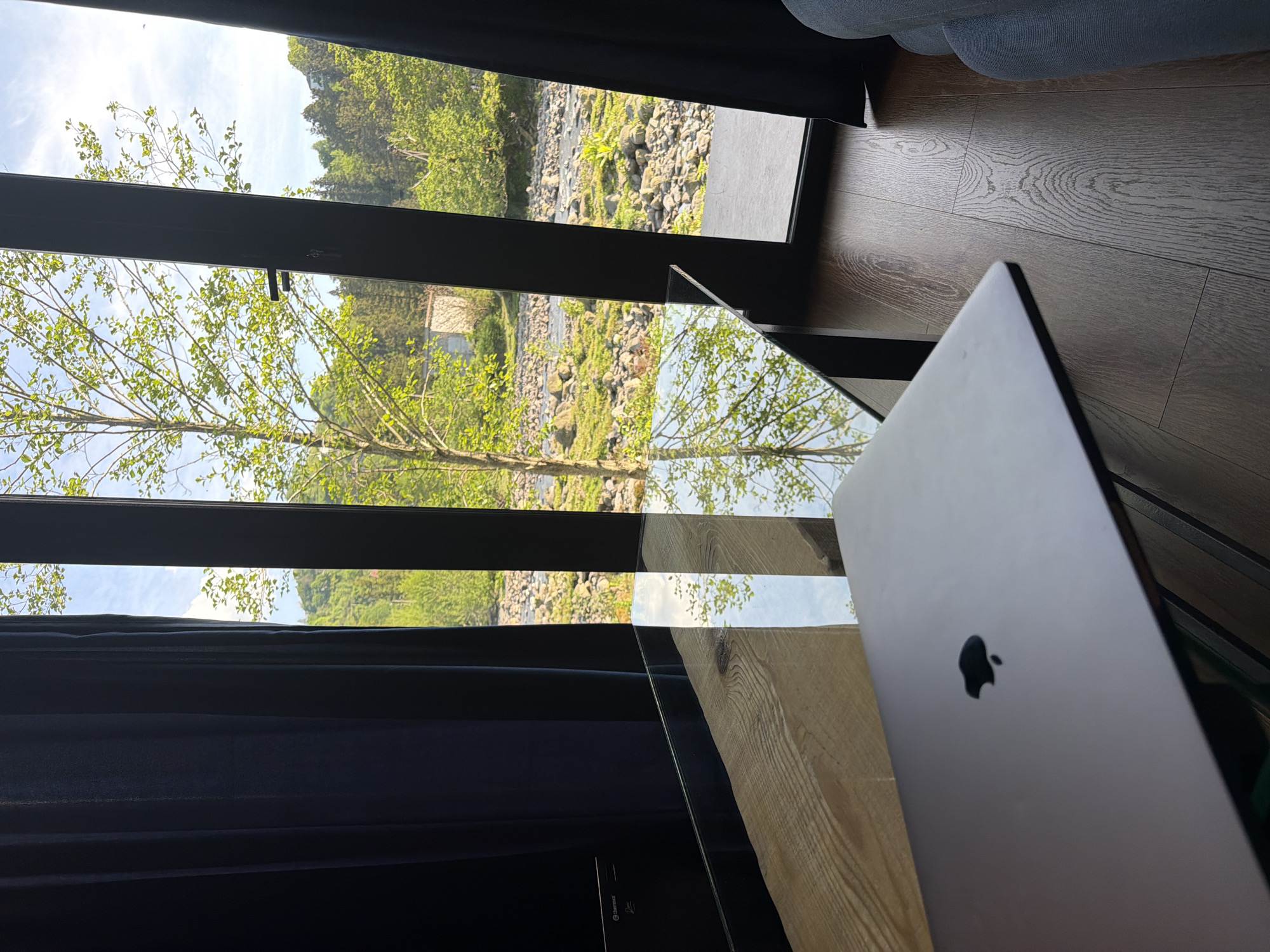 MacBook setup overlooking river landscape in Kapreshumi, Georgia