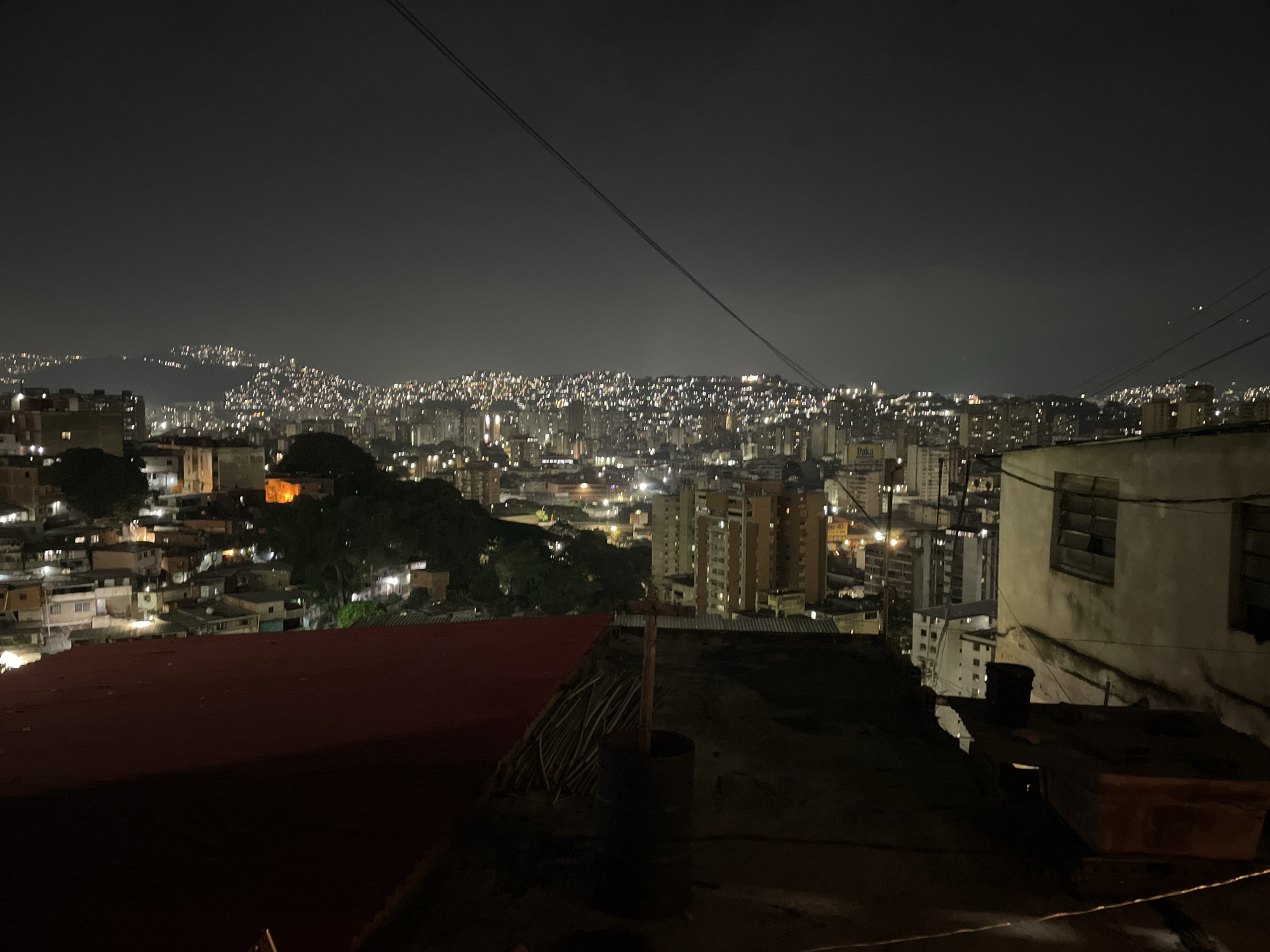 Nighttime rooftop view captured over Caracas residential area
