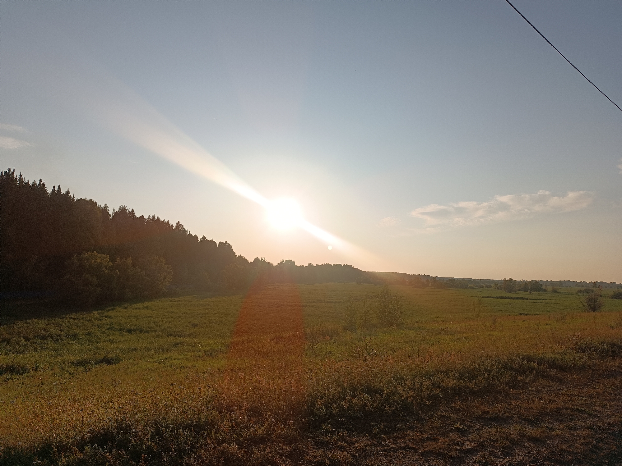 Golden hour across fields and water in Alexandrovskoe, Russia