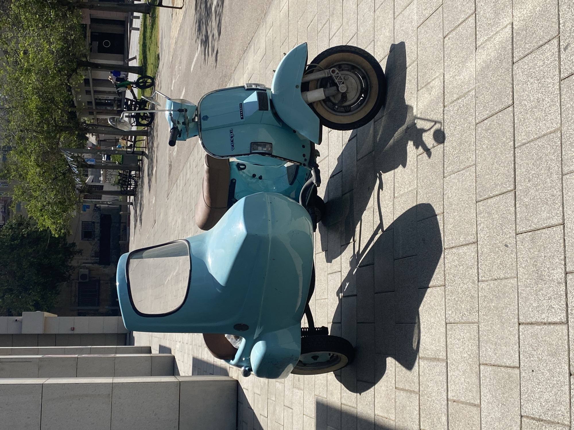Vintage blue Vespa with sidecar spotted on Tel Aviv sidewalk