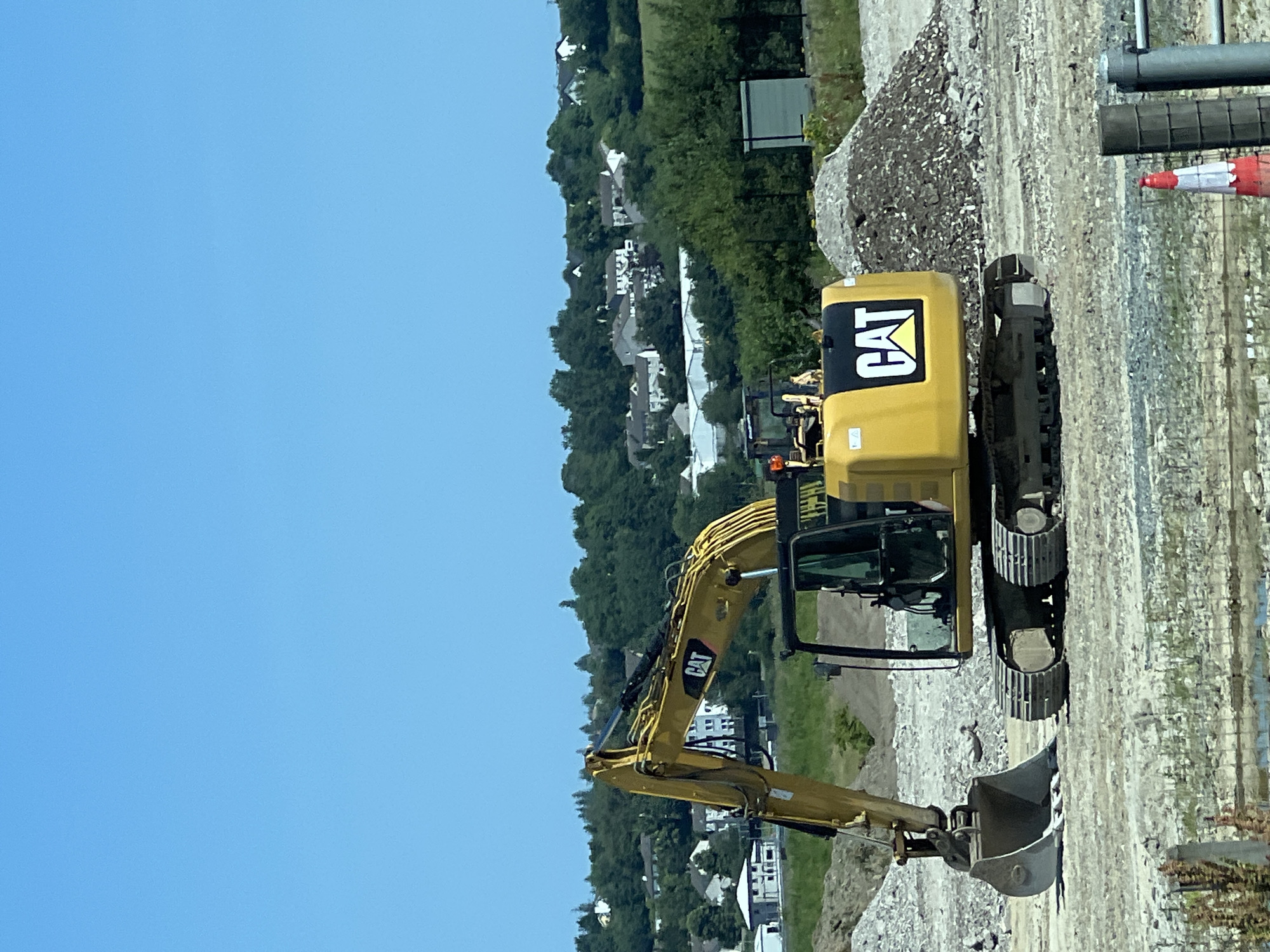 Caterpillar excavator on a clear-sky construction site in Letterkenny