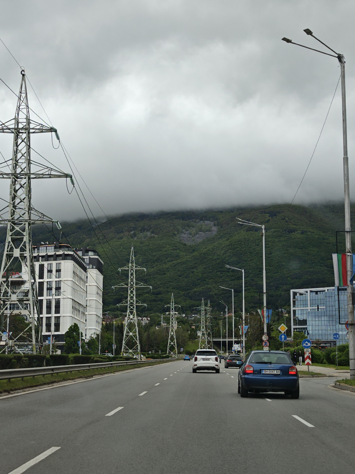 Sofia street view captured showing urban road, mountain backdrop