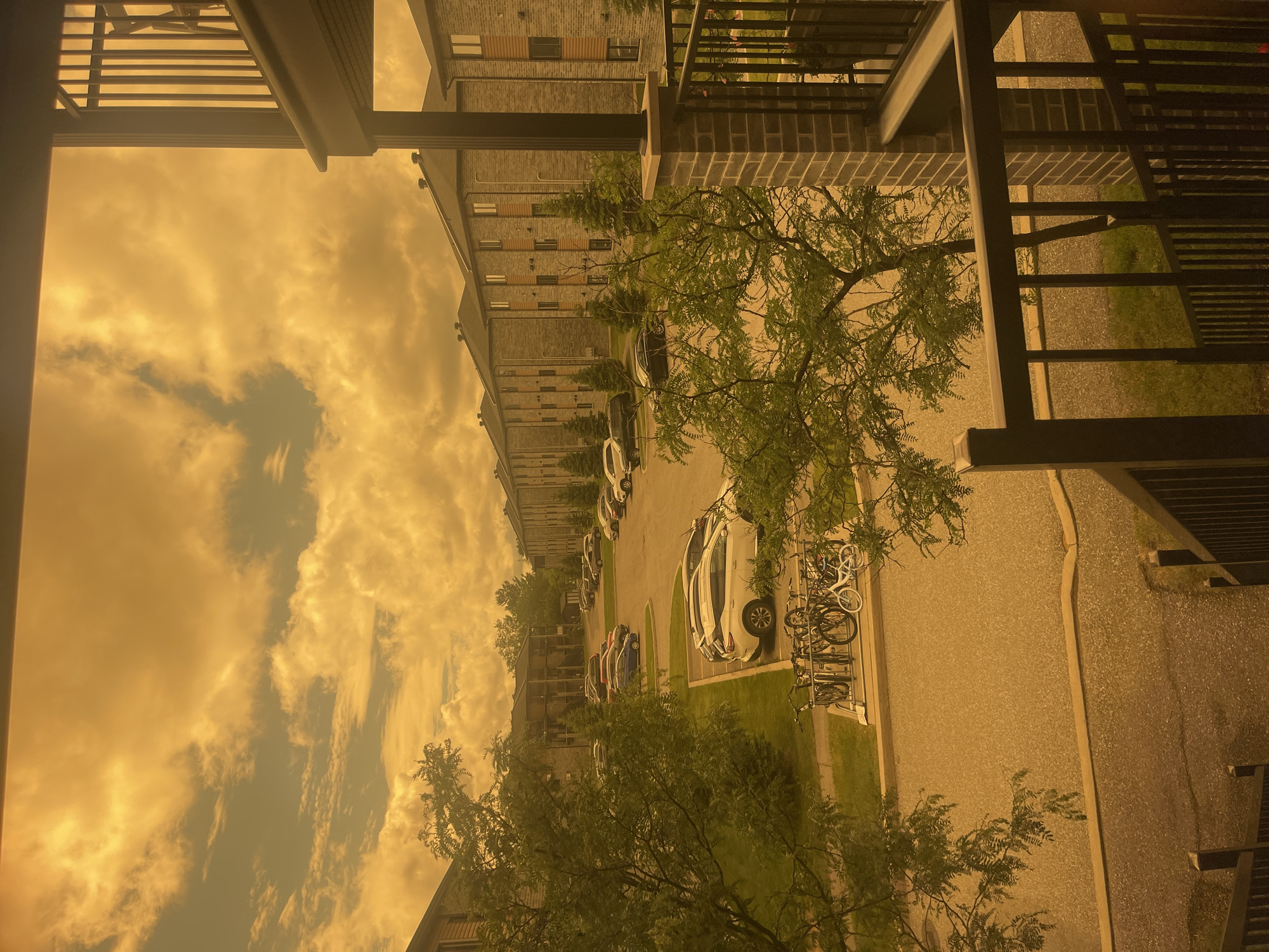 Balcony evening in Gatineau under a smoke-tinged orange sky