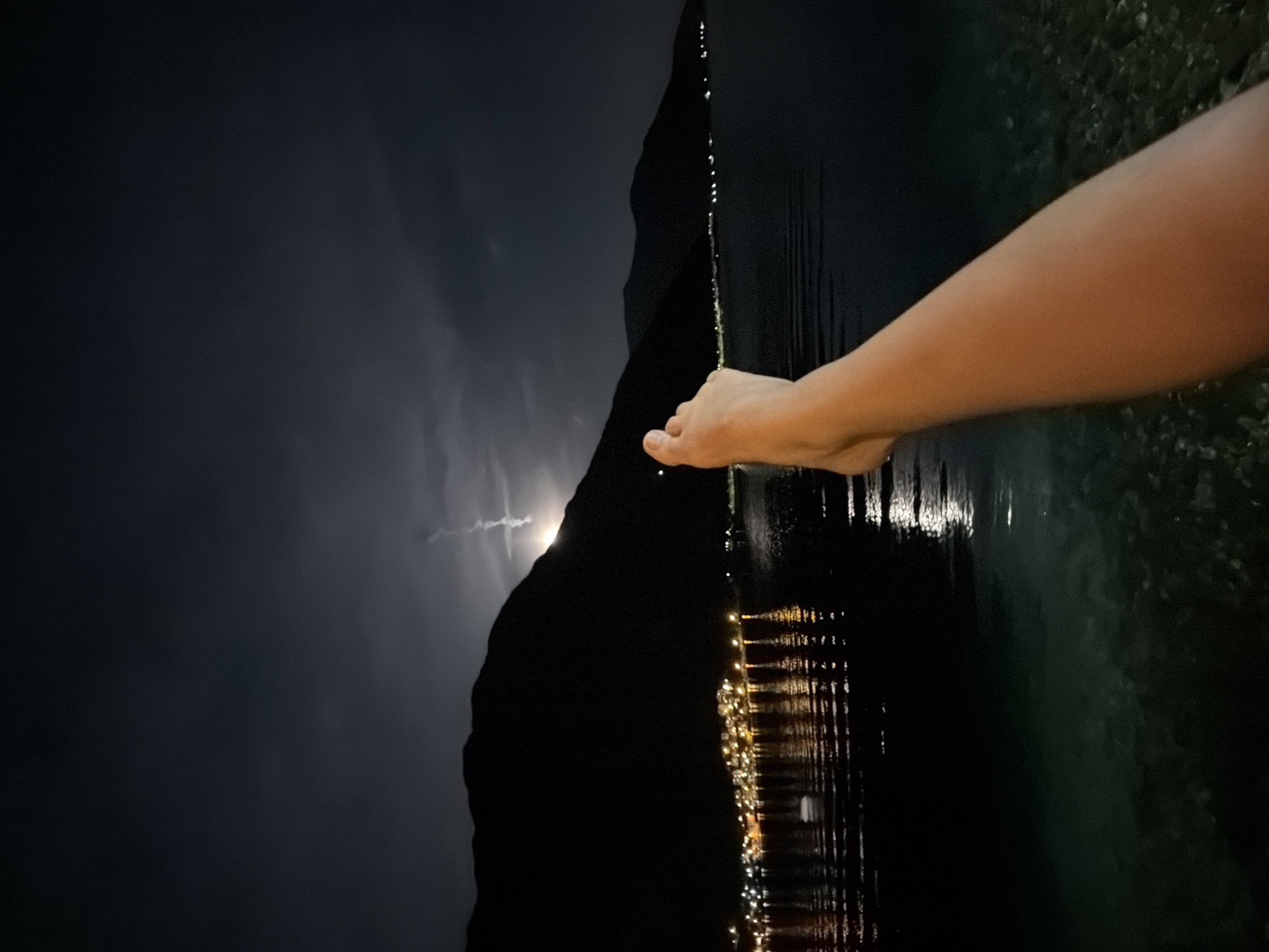 Night photography captures Risan city lights reflecting on water