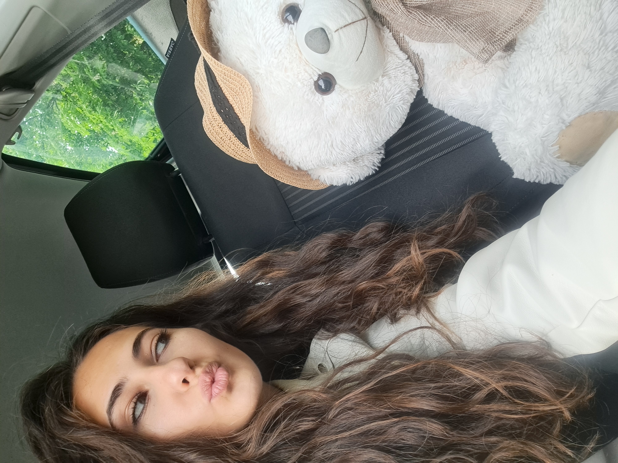 Woman photographed with stuffed bear, tea mugs captured early morning