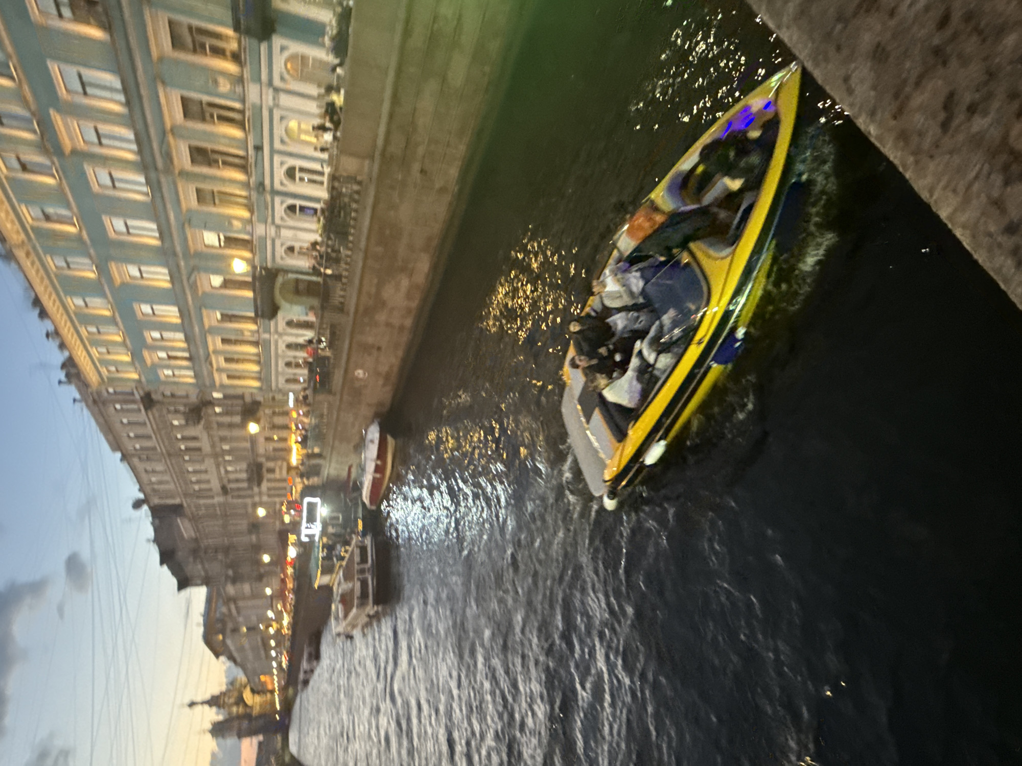 Motorboat cruising St. Petersburg canals at dusk
