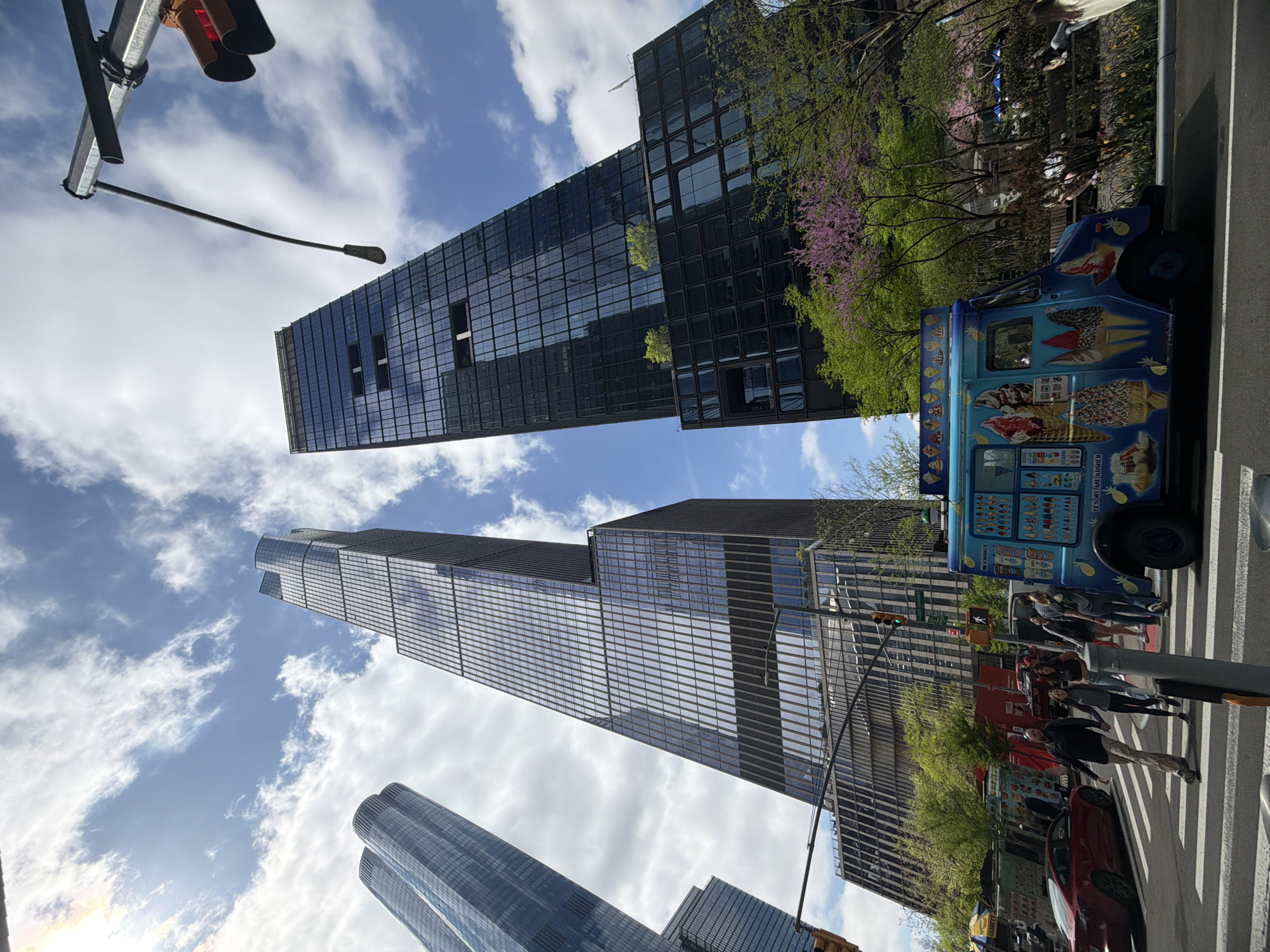 NYC street scene with skyscrapers and ice cream vendor observed