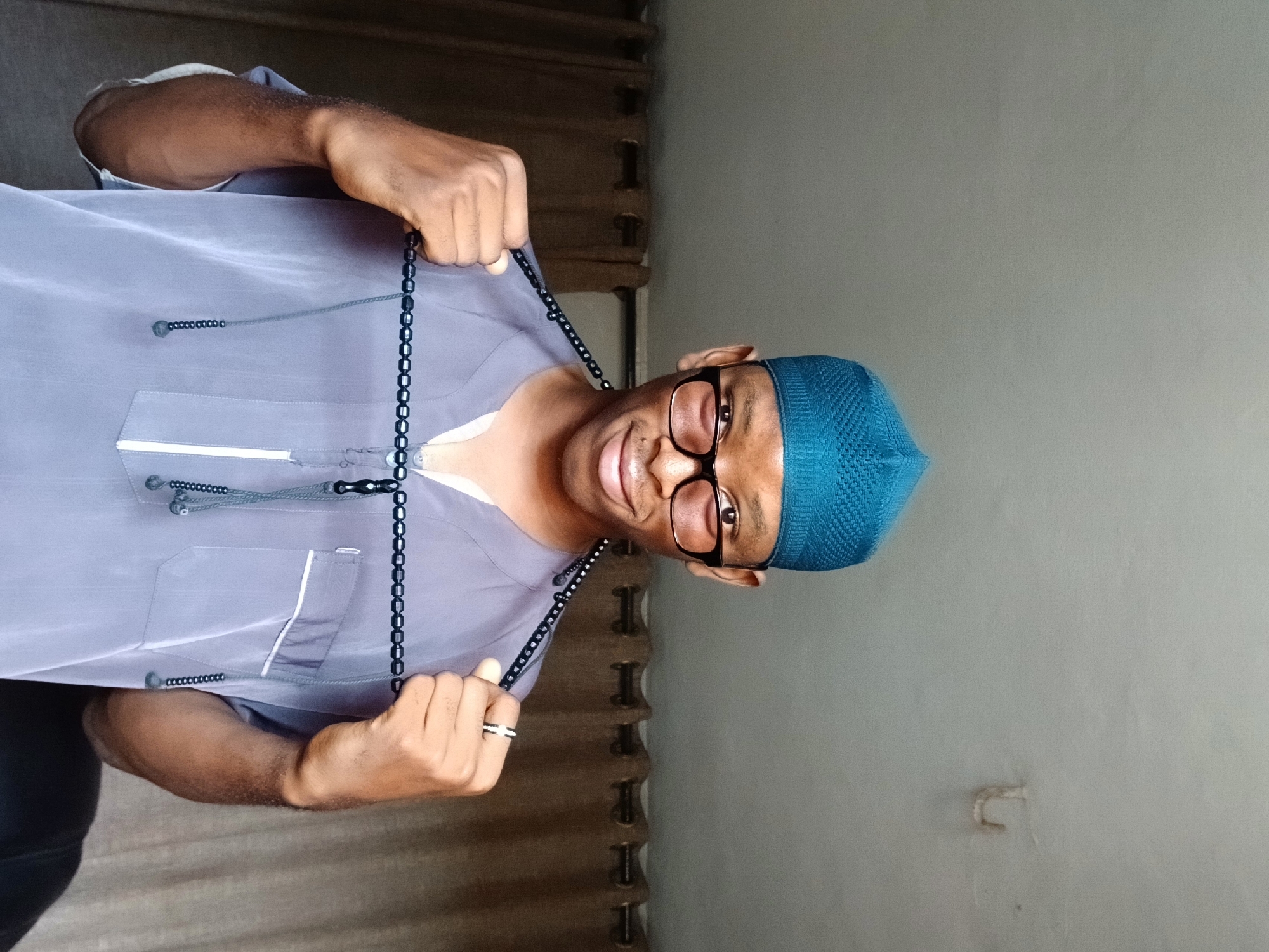 Man in traditional dress photographed repeatedly in Lagos home