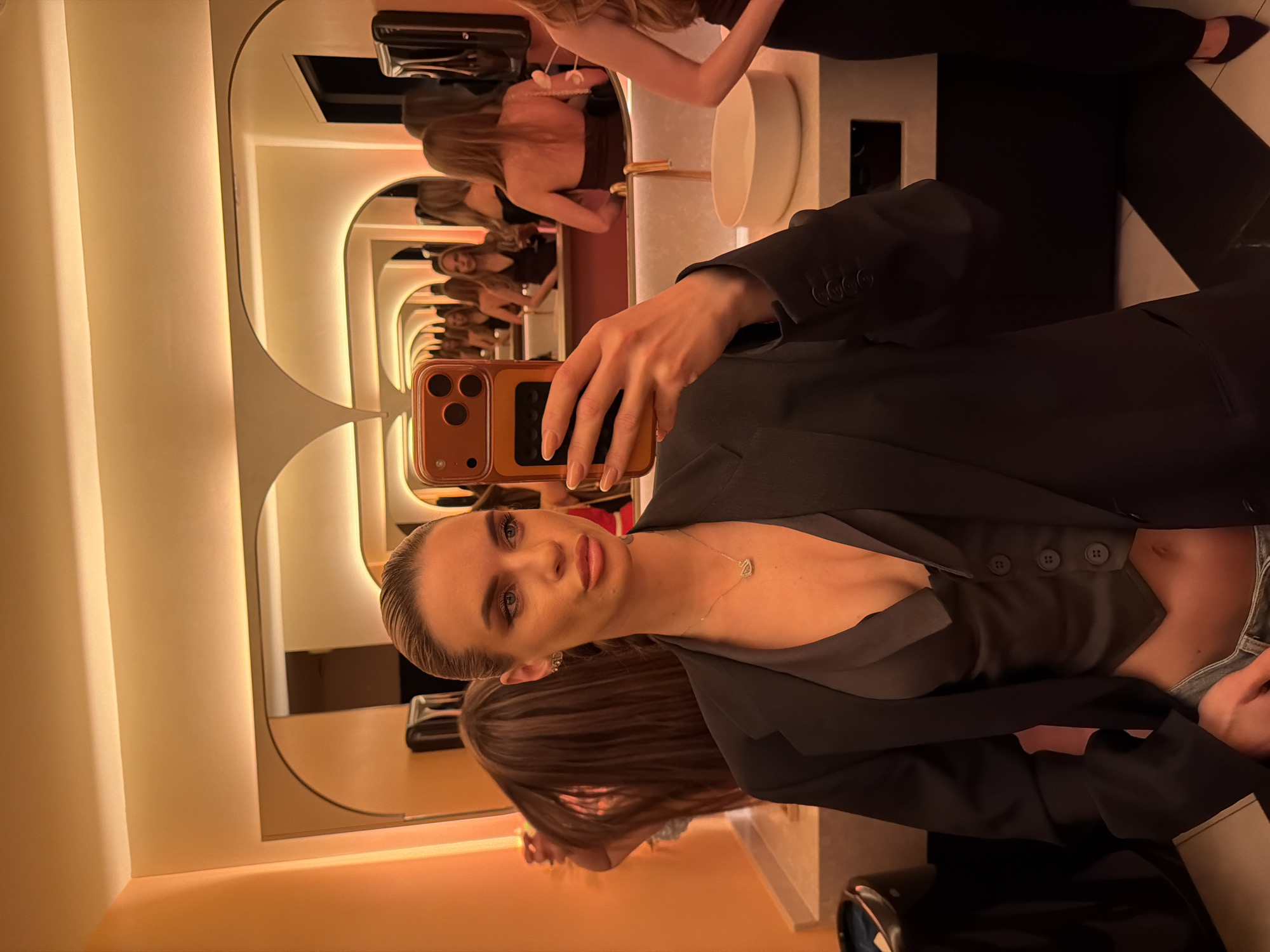 Woman takes bathroom selfie in Berlin wearing business attire