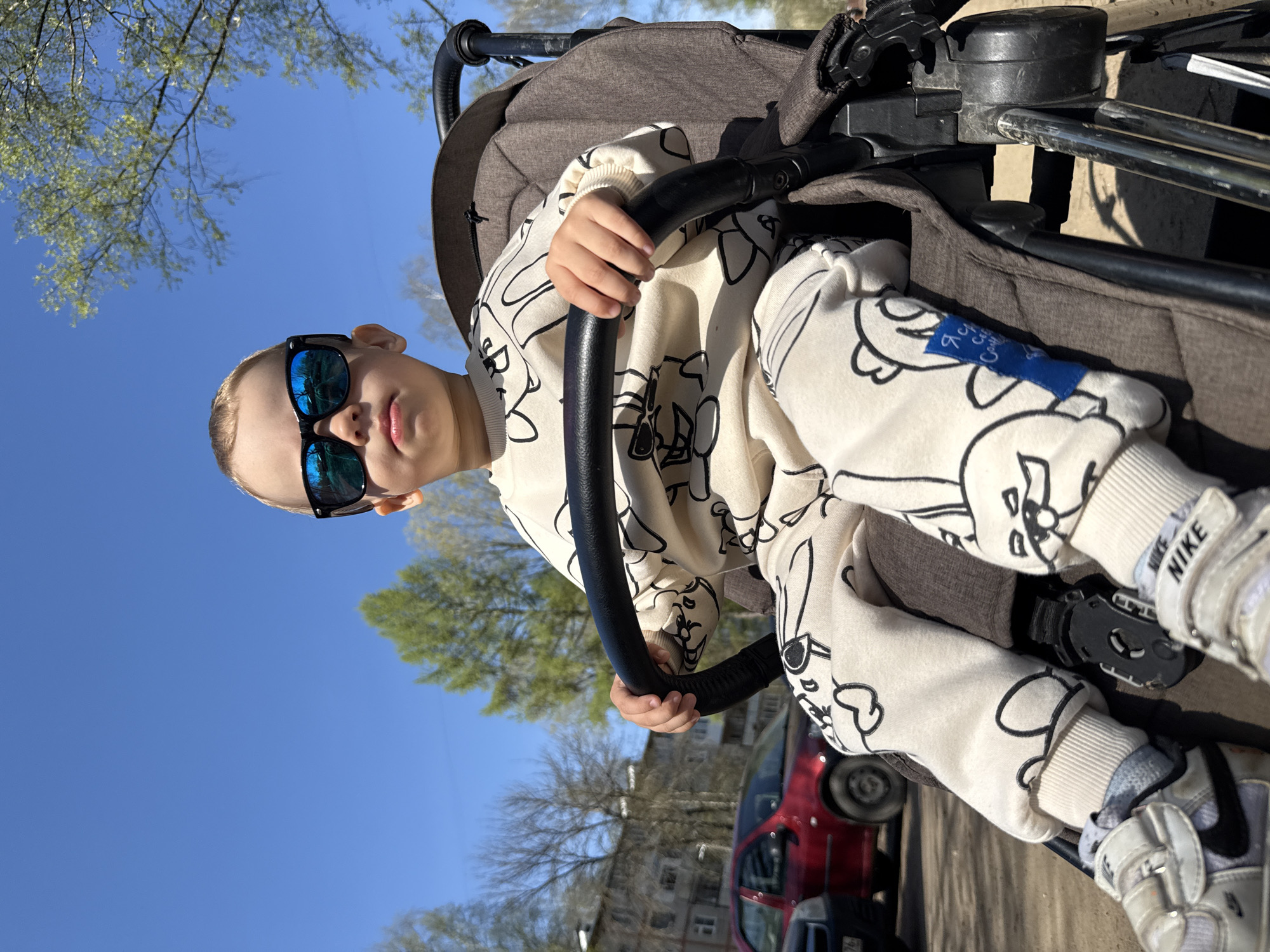 Mother and child enjoy morning stroller outing in Rusanovo