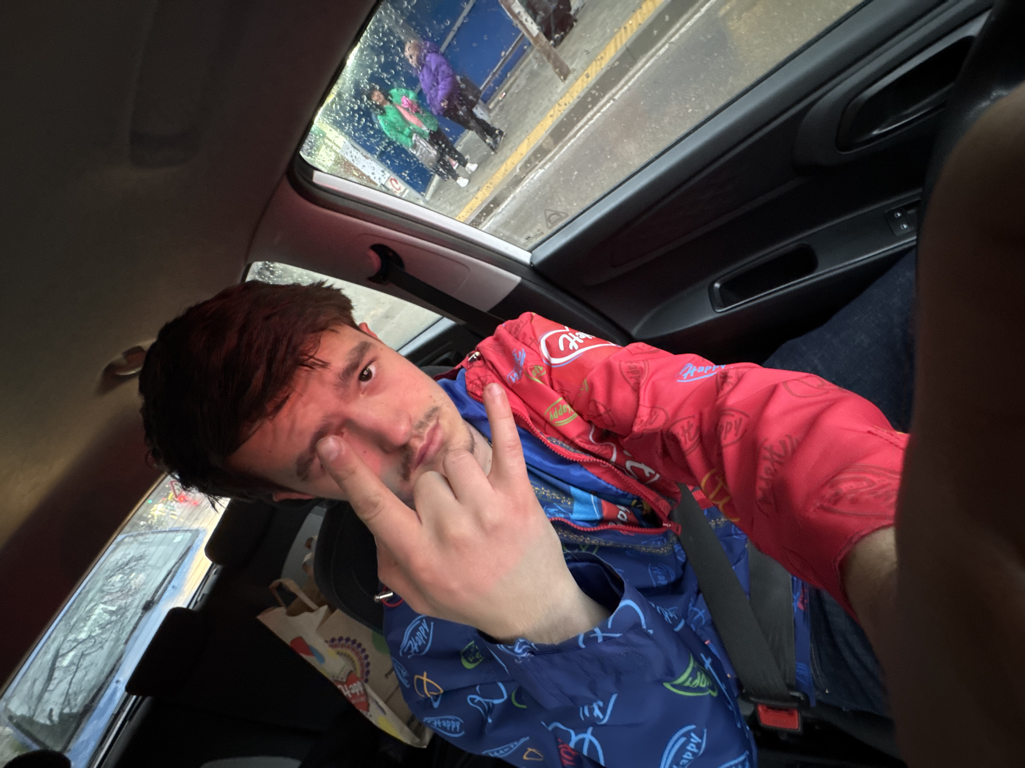 Driver takes selfies while driving through rainy Sofia
