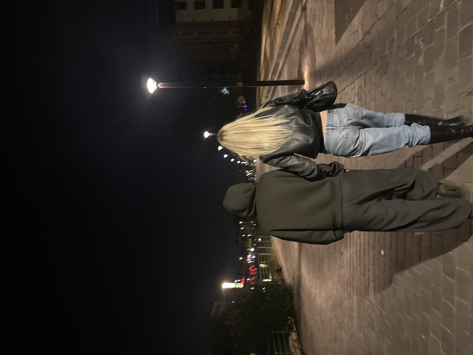 Two people walk nighttime Paris pathway near Sacré-Cœur