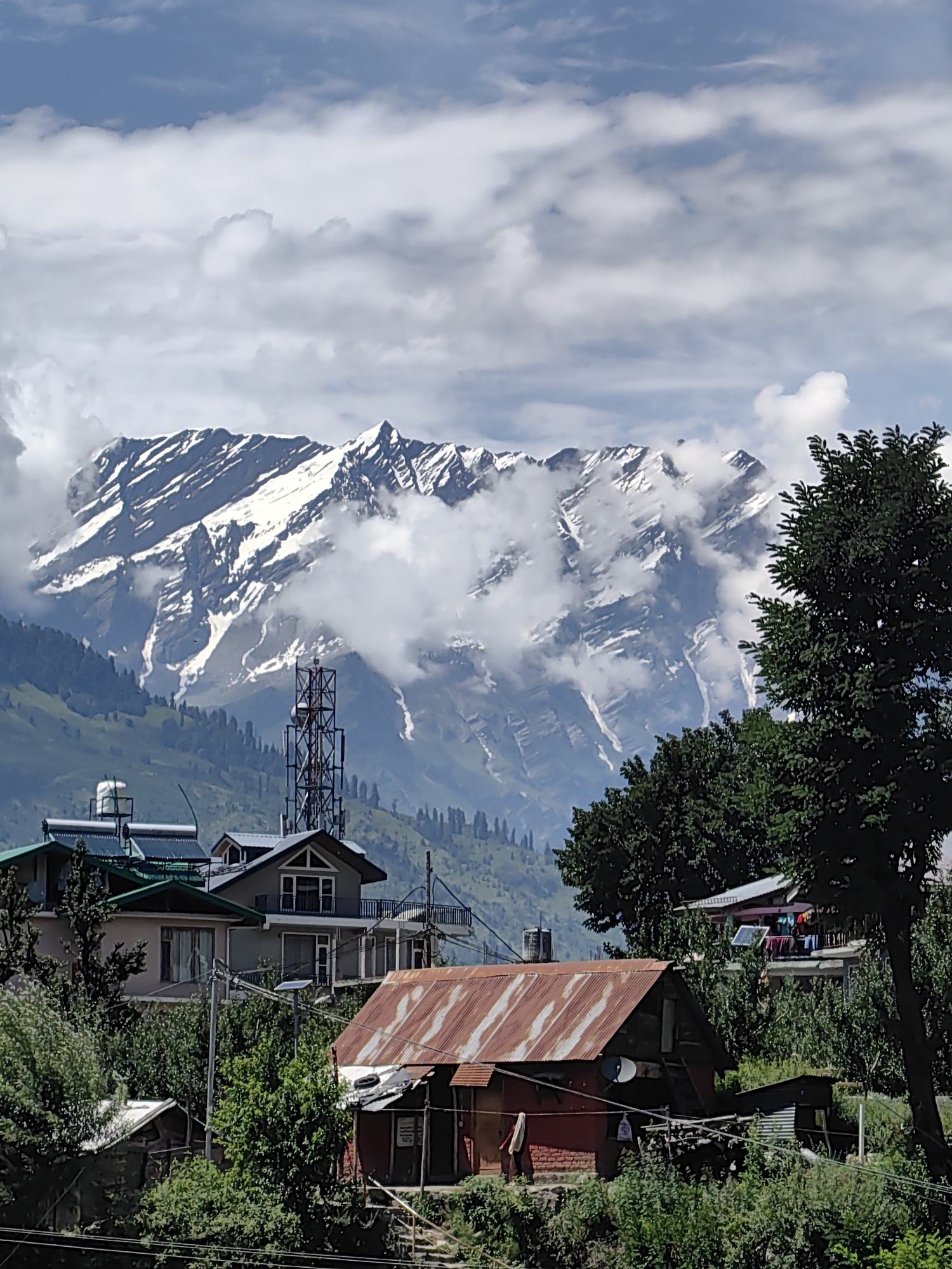 Snow-capped Himalayas loom over Aleo village buildings