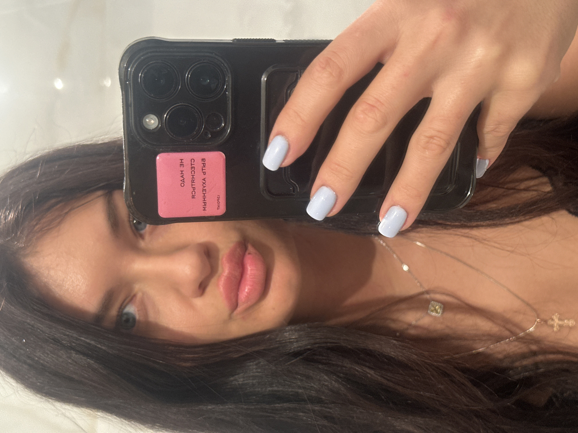 Woman takes mirror selfie indoors in Moscow