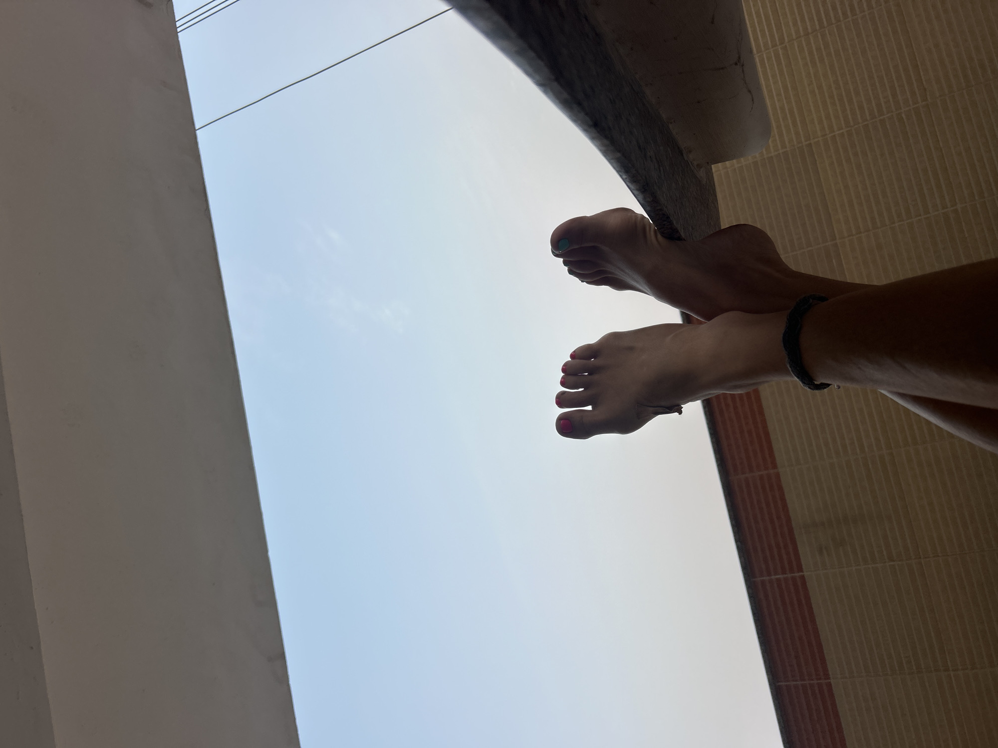 Low-angle photos capture feet and architecture in Puttaparthi