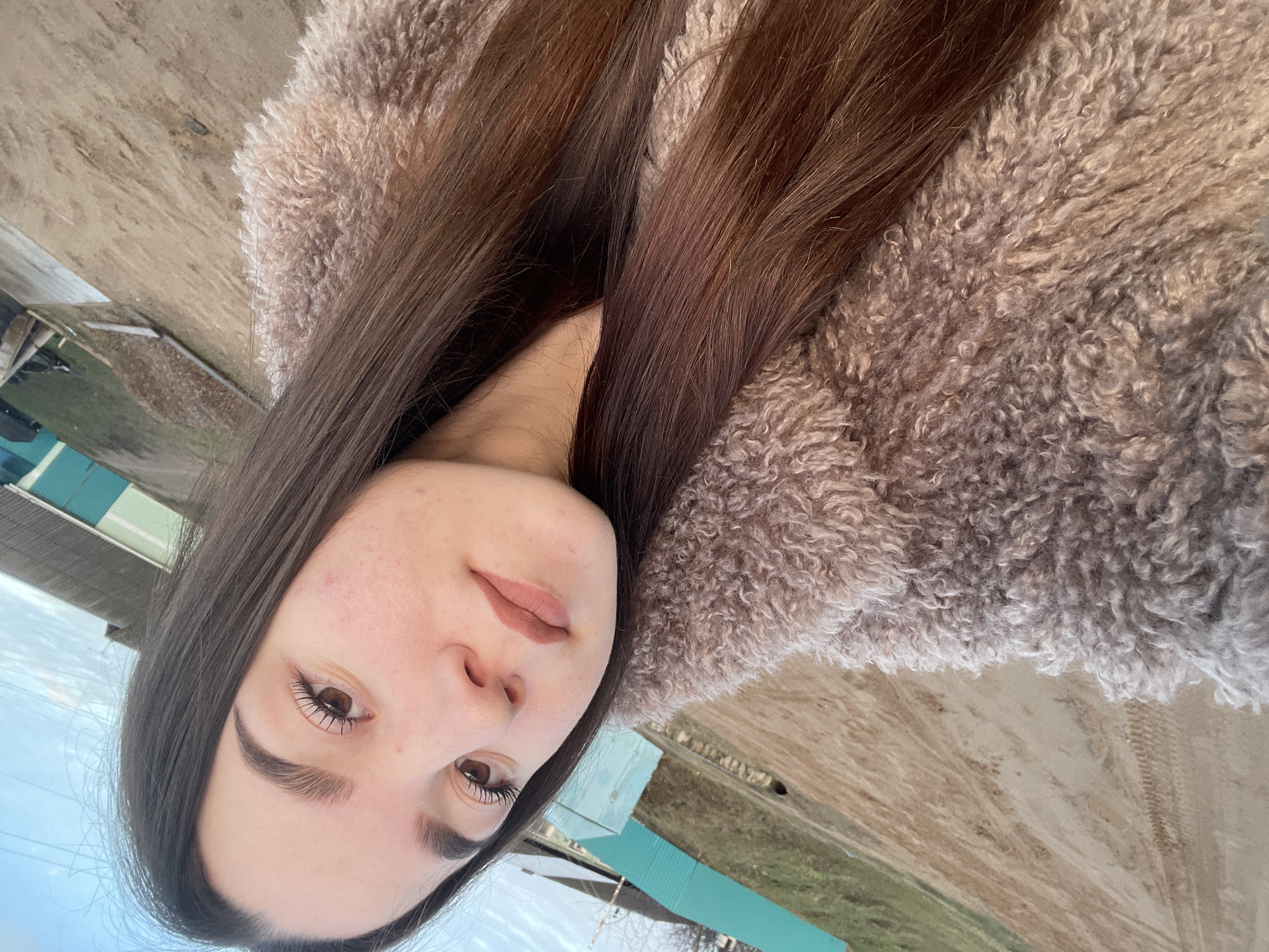 Woman takes selfies during golden hour in rural Russia