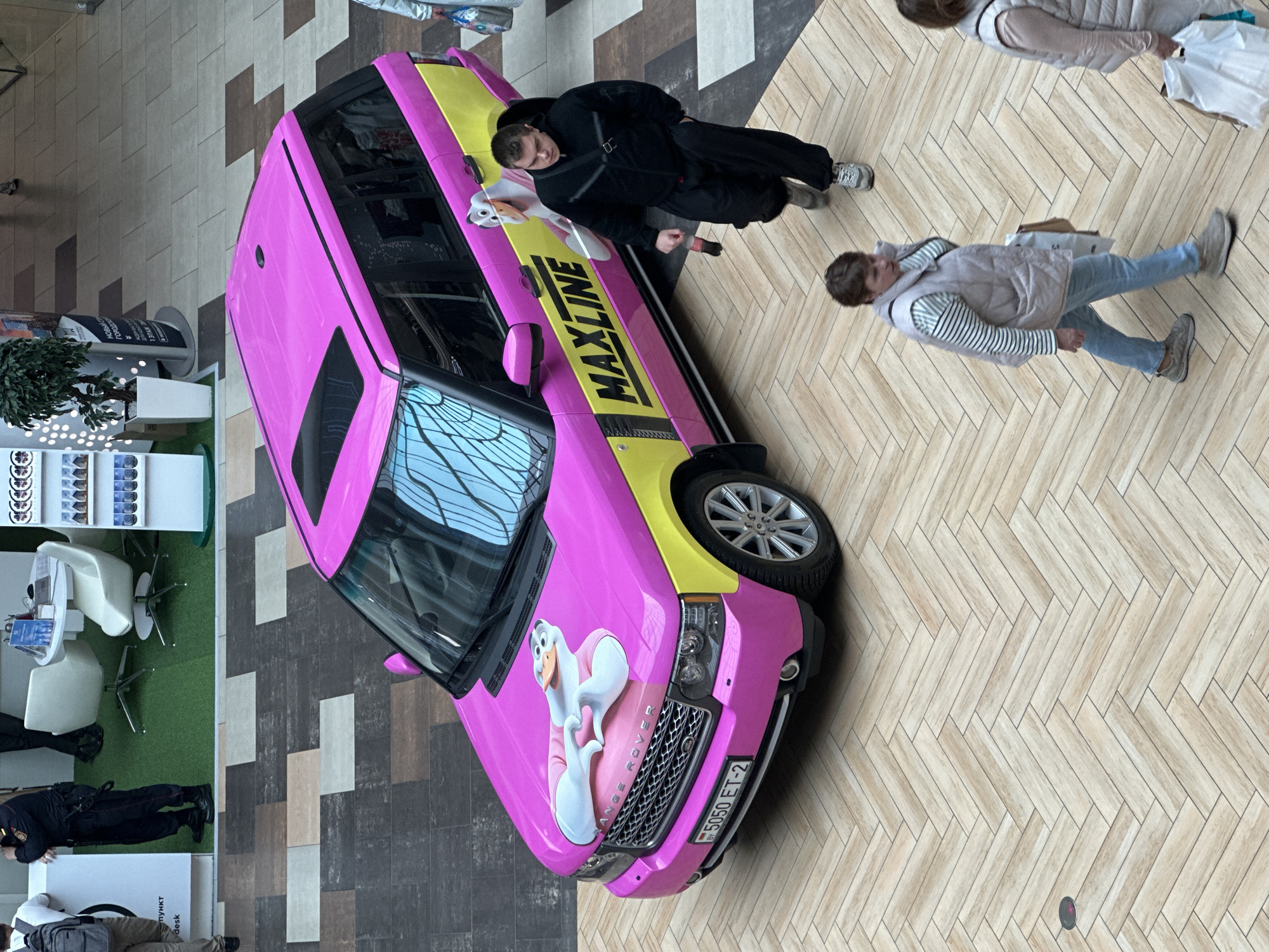 Inside Dana Mall, Minsk, with a pink branded Range Rover on display
